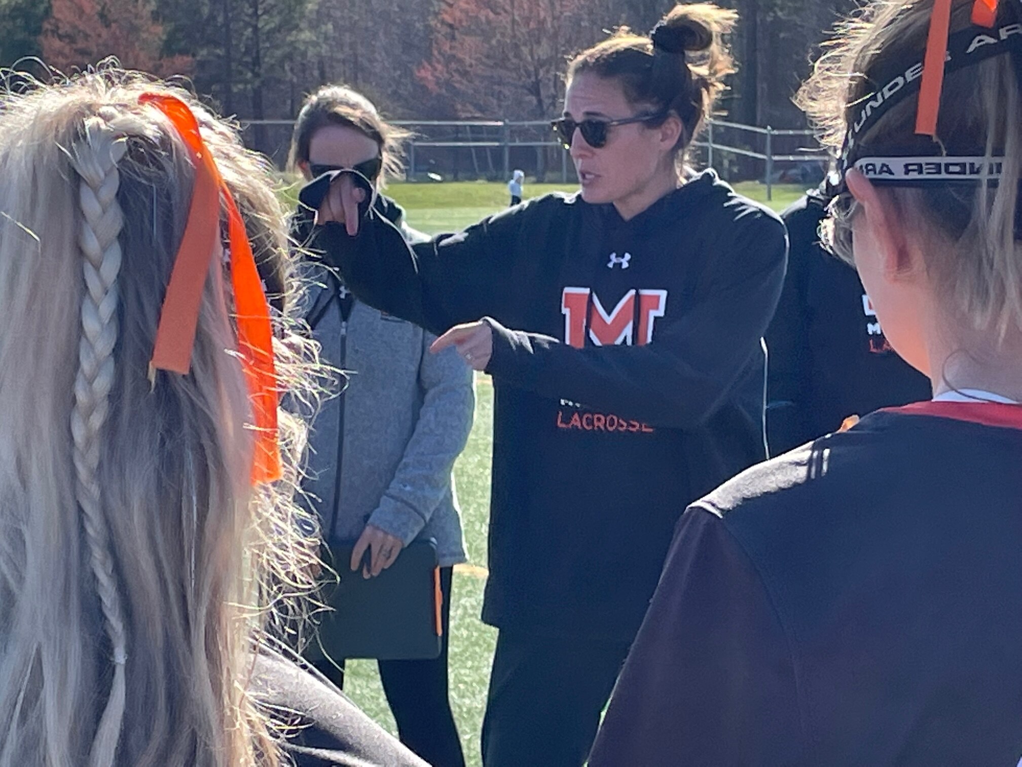 McDonogh coach Taylor Cummings gives her Eagles advice at halftime of 13-7 win at Archbishop Spalding during the 2023 season. The Eagles would conclude the season with their second IAAM A Conference championship during Cumming's six year tenure as the team's head coach, which concluded when she resigned last week.