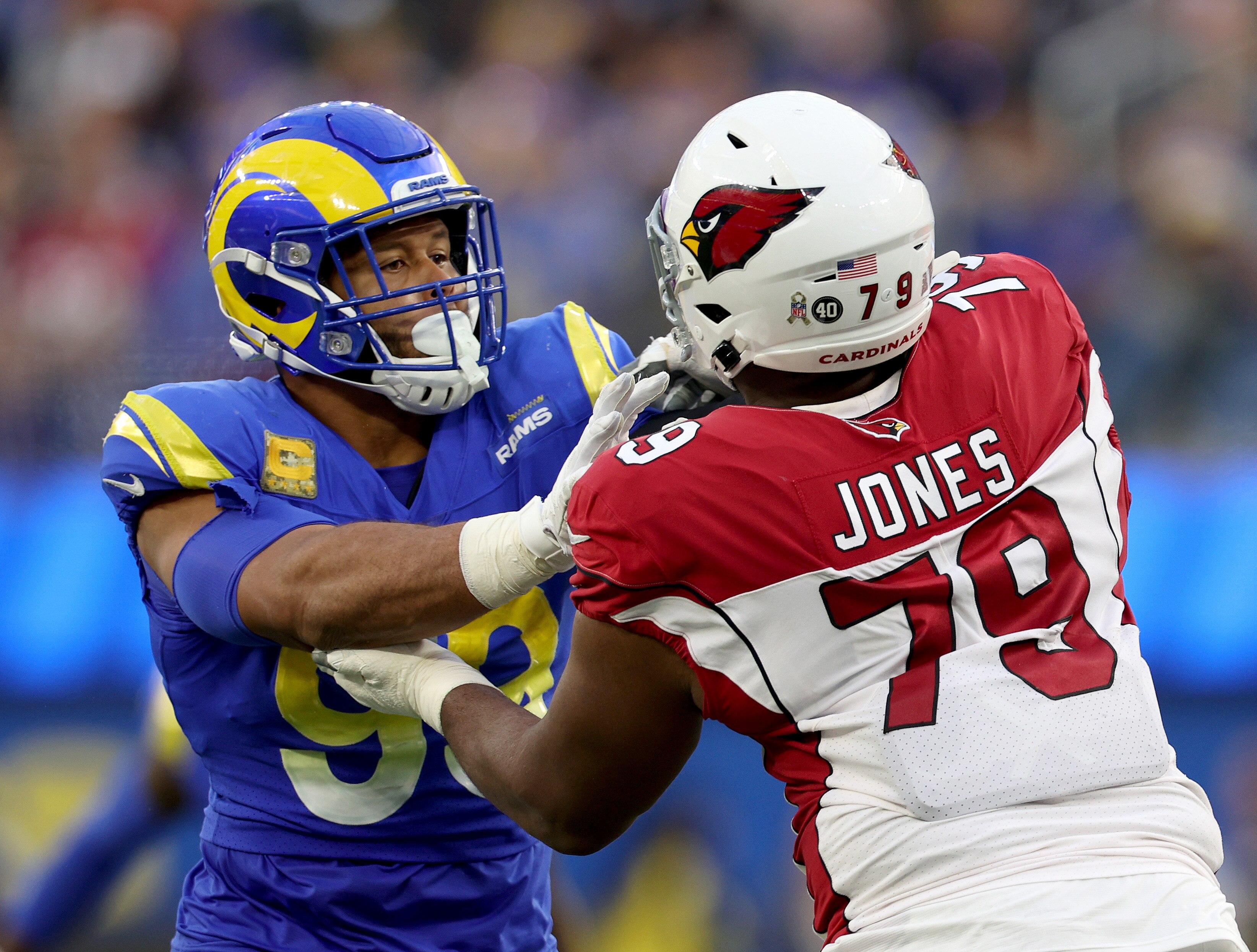 Josh Jones of the Arizona Cardinals blocks Aaron Donald of the Los Angeles Rams during a 2022 game.