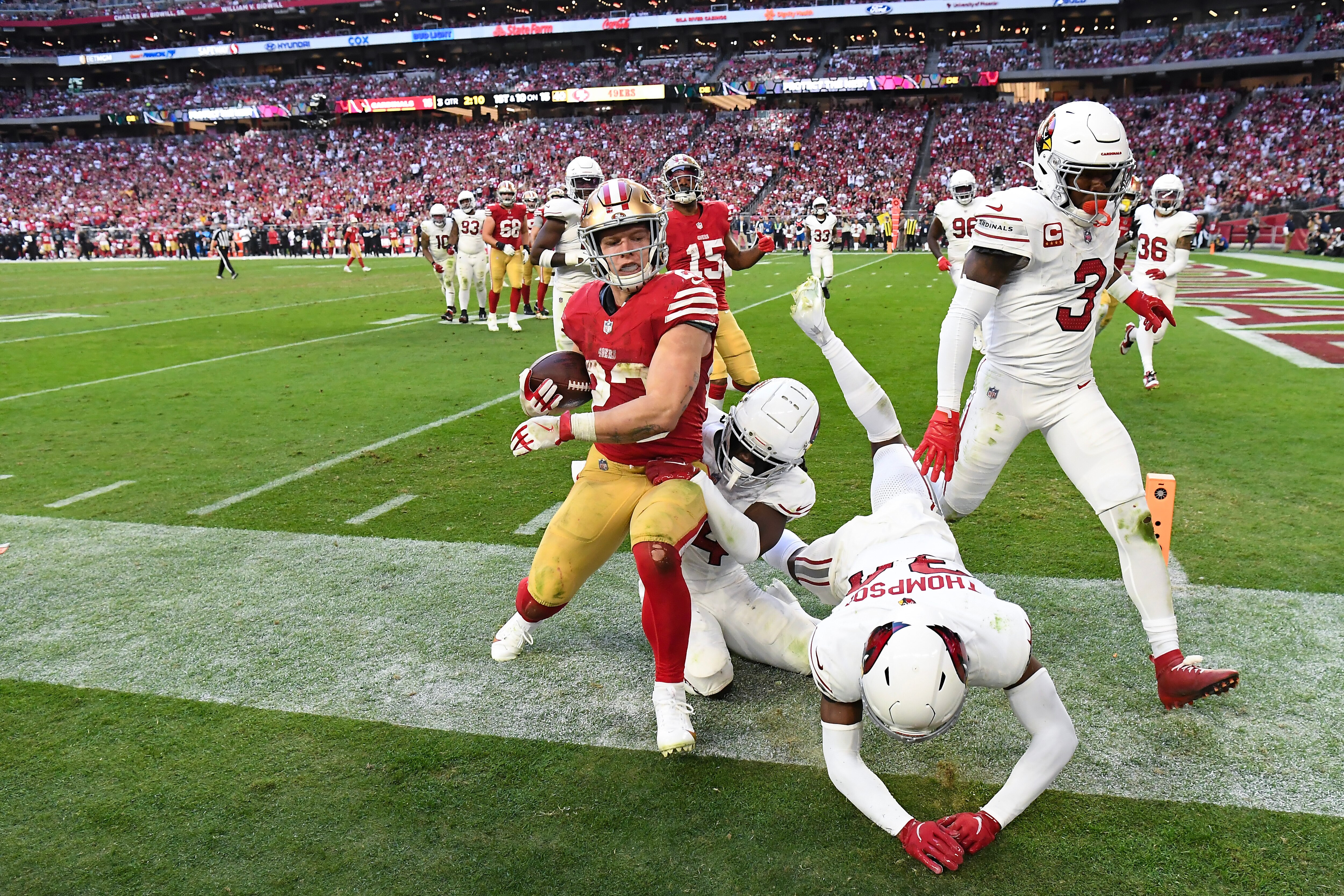 49ers running back Christian McCaffrey is forced out of bounds by a group of Arizona Cardinals defenders during the fourth quarter.