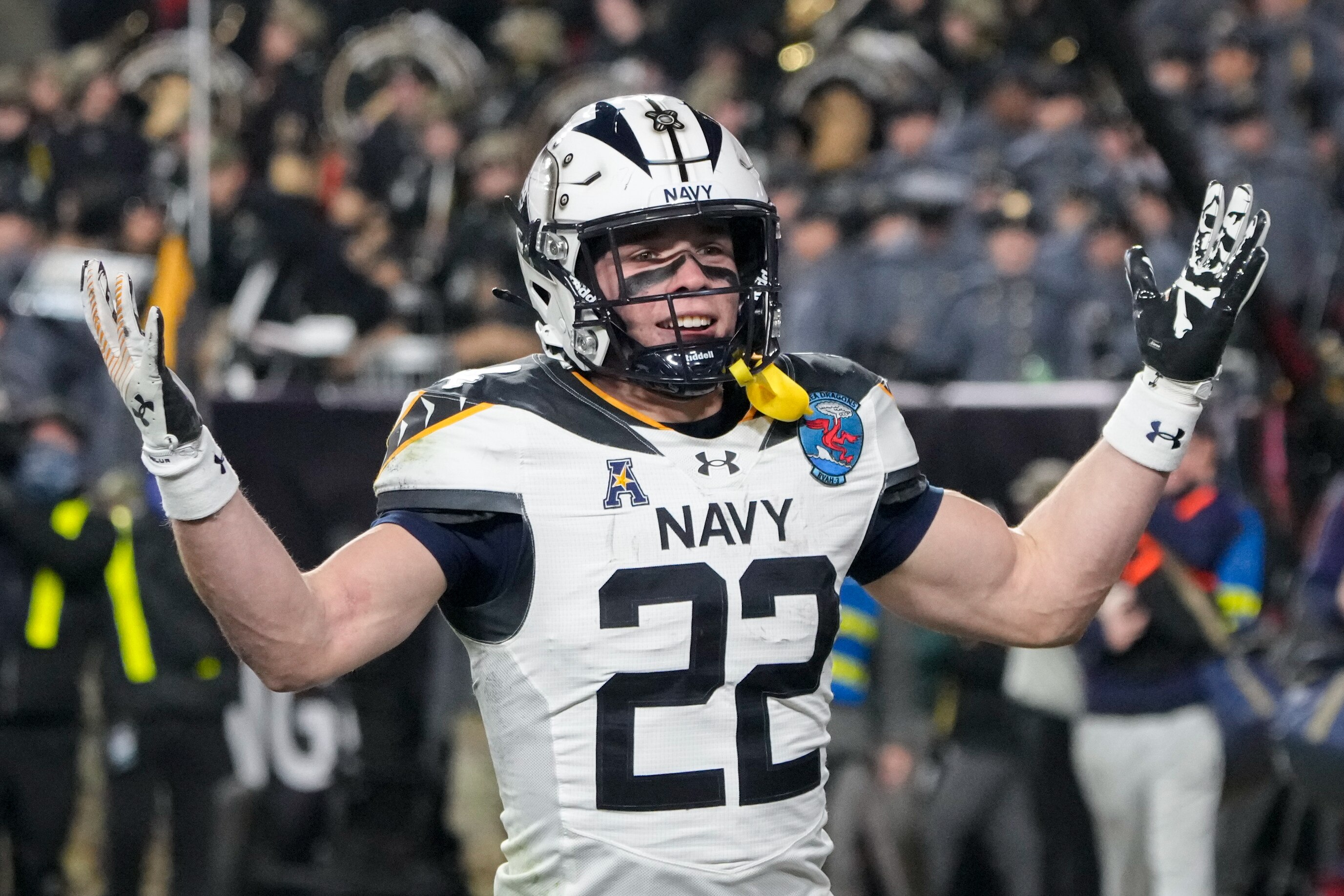 Navy receiver Eli Heidenreich (22) celebrates near his fellow midshipmen after scoring a touchdown during the 125th Annual Army-Navy Game held at Northwest Stadium  in Landover, Md. on Saturday, December 14, 2024.