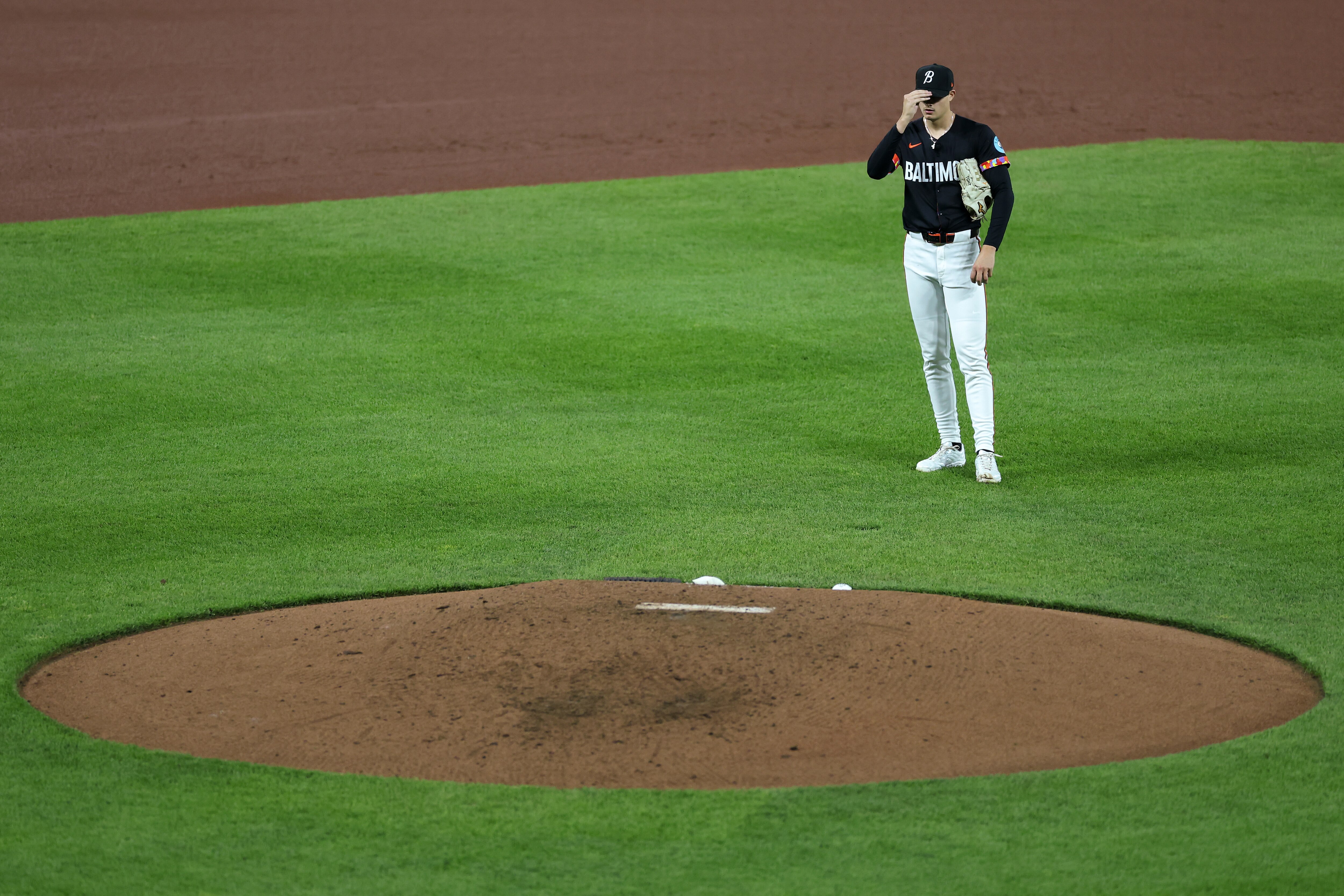 BALTIMORE, MARYLAND - APRIL 18: Starting pitcher Cade Povich #37 of the Baltimore Orioles reacts after allowing a three run home run to Matt McLain #9 of the Cincinnati Reds during the fourth inning at Oriole Park at Camden Yards on April 18, 2025 in Baltimore, Maryland.