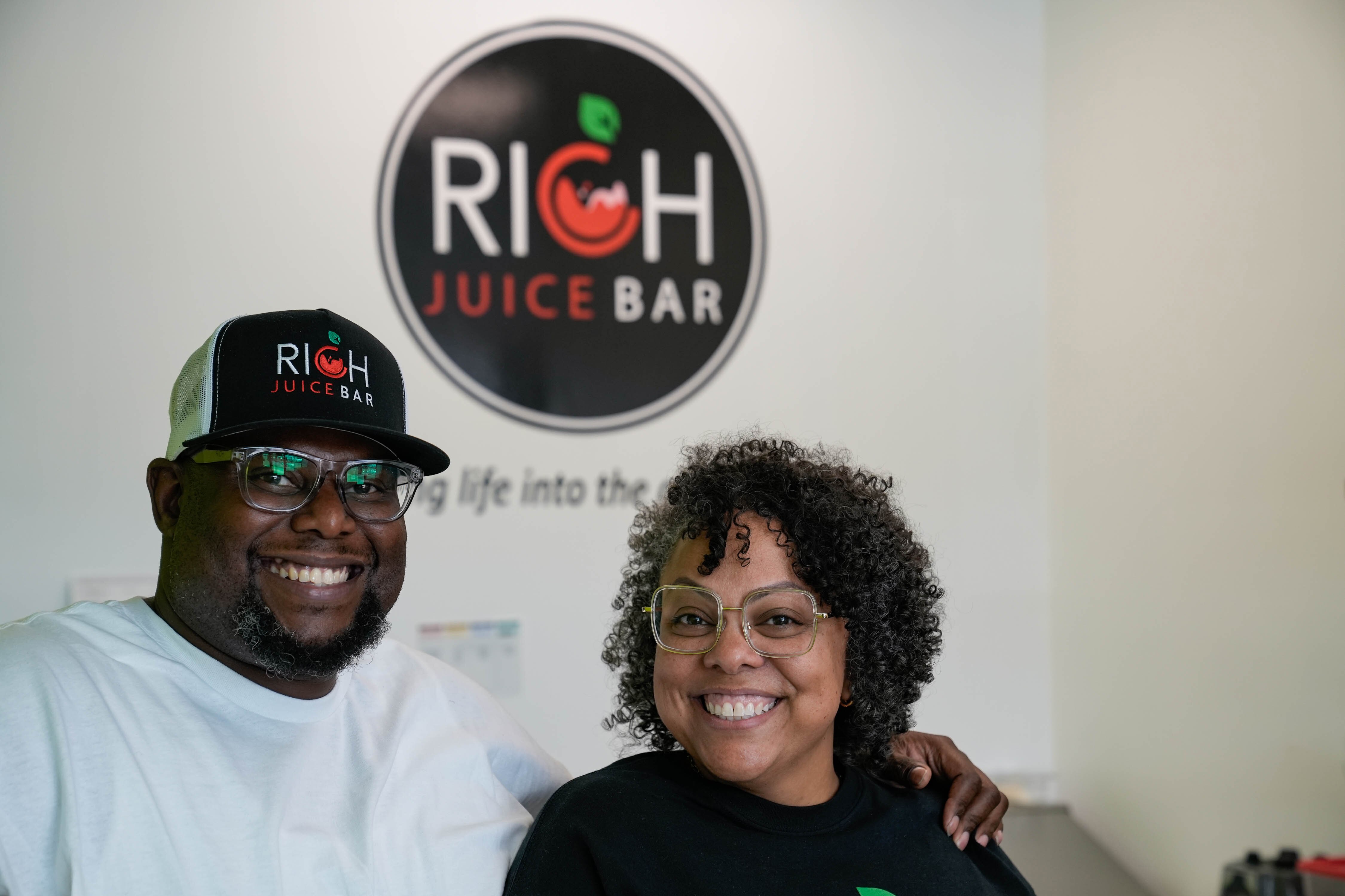 Michael Battle Jr. and Dani Battle, founders of the RICH Program, stand in the RICH Juice Bar on Wednesday, June 14, 2023.