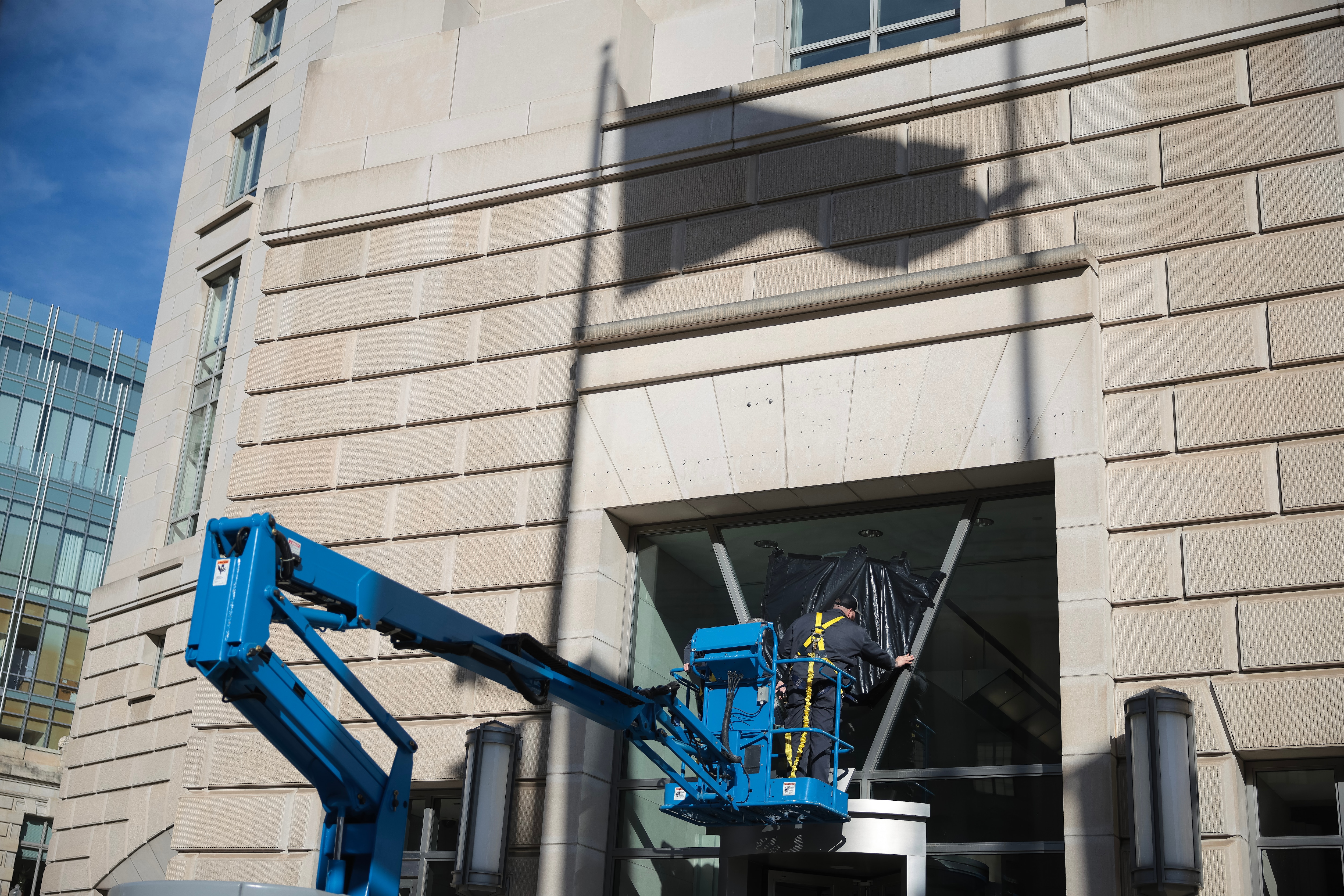 WASHINGTON, DC - FEBRUARY 07: A worker removes the U.S. Agency for International Development sign on their headquarters on February 07, 2025 in Washington, DC. President Donald Trump and Elon Musk's Department of Government Efficiency (DOGE) abruptly shutdown the U.S. aid agency earlier this week leaving thousands unemployed and putting U.S. foreign diplomacy and aid programs in limbo.