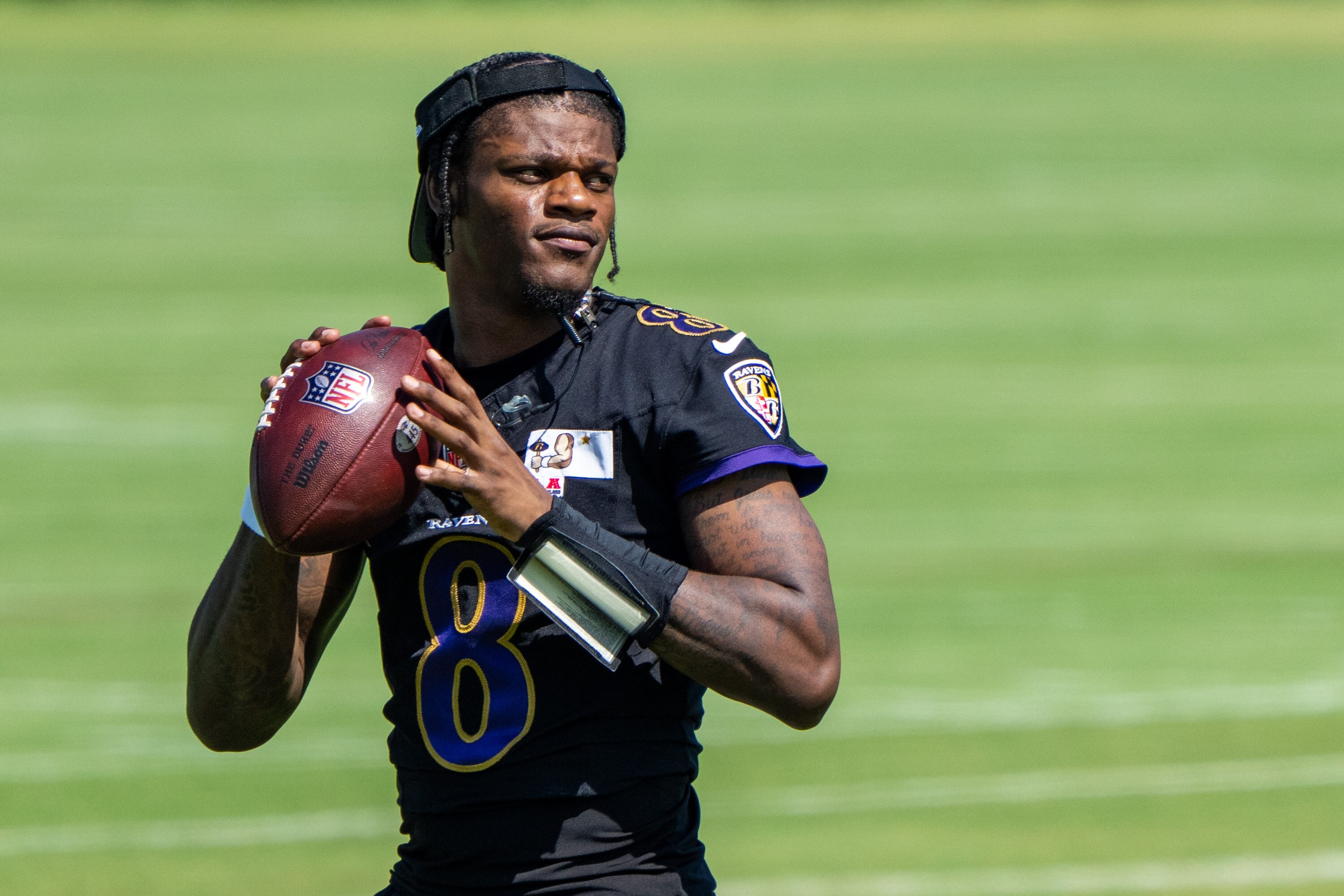 Quarterback Lamar Jackson looks to throw during the third day of Ravens minicamp on June 13, 2024.
