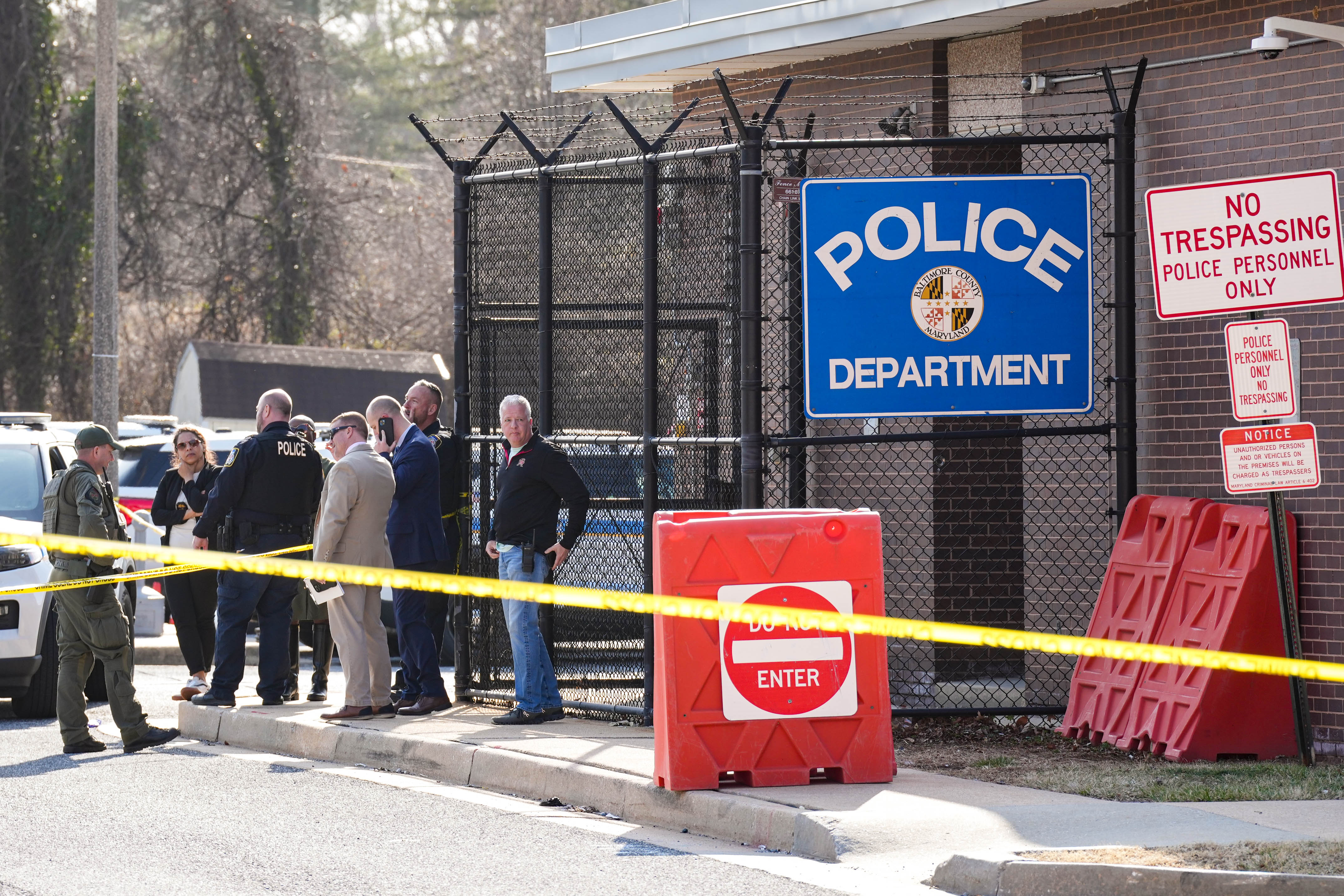 Police officers gather outside a southwest Baltimore County Police precinct following a shooting in the parking lot on Thursday.