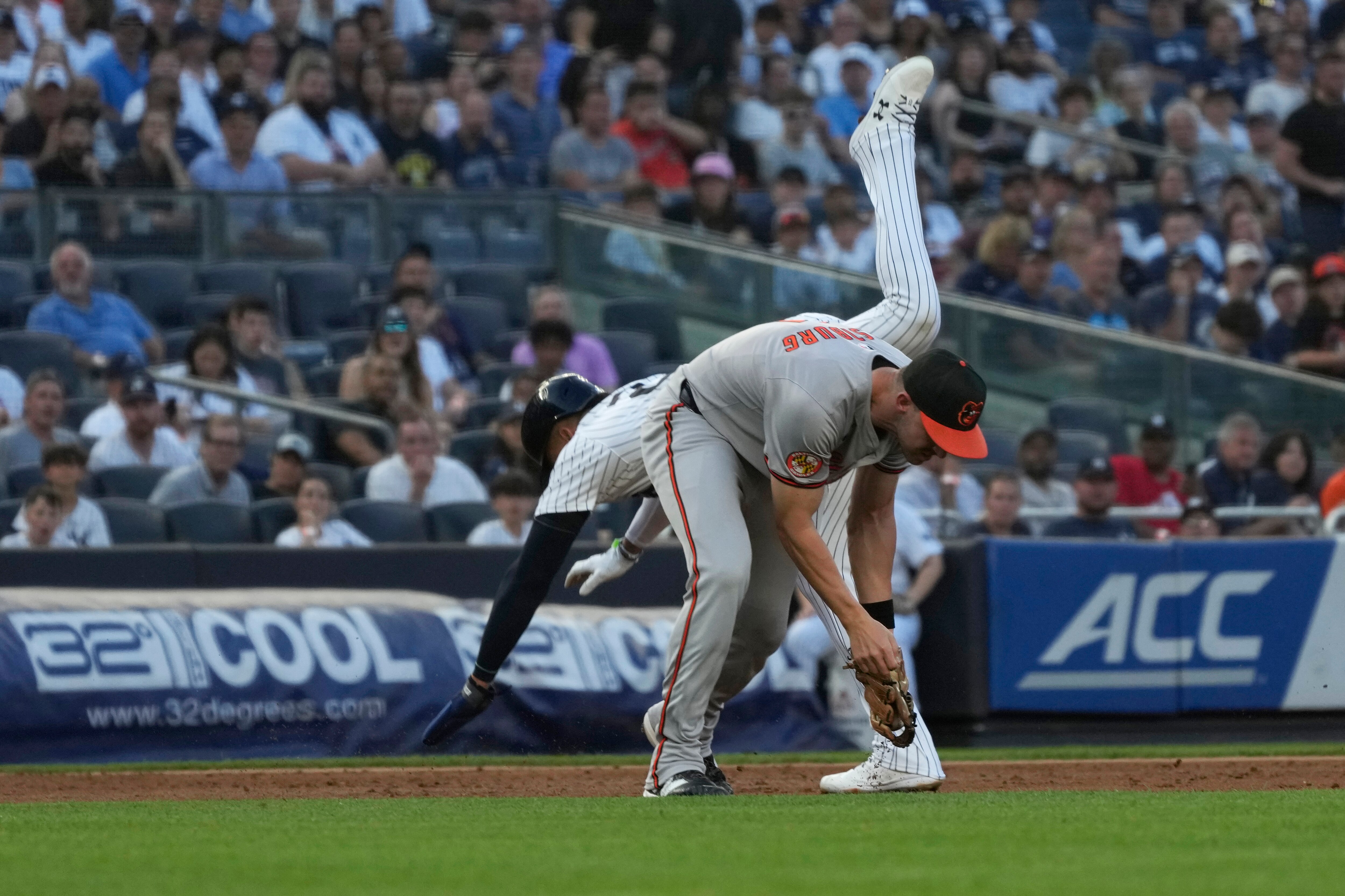 New York Yankees’ Juan Soto and Baltimore Orioles third baseman Jordan Westburg collide as Soto was forced out at third base during the first inning of a baseball game Tuesday, June 18, 2024, in New York.