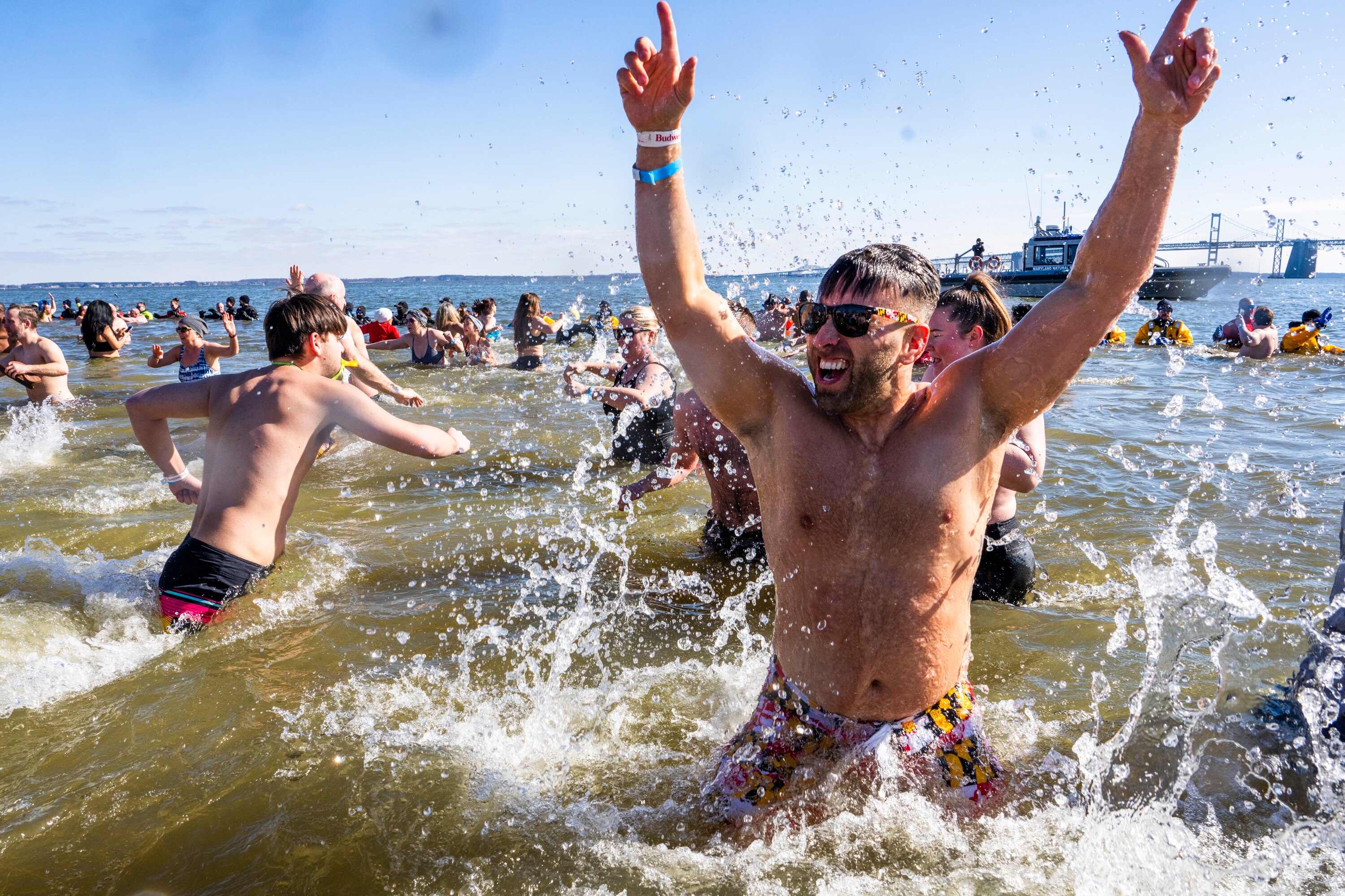 Hundreds of people run into the icy Chesapeake Bay to raise funds for Special Olympics during the annual Polar Bear Plunge at Sandy Point State Park on Saturday.