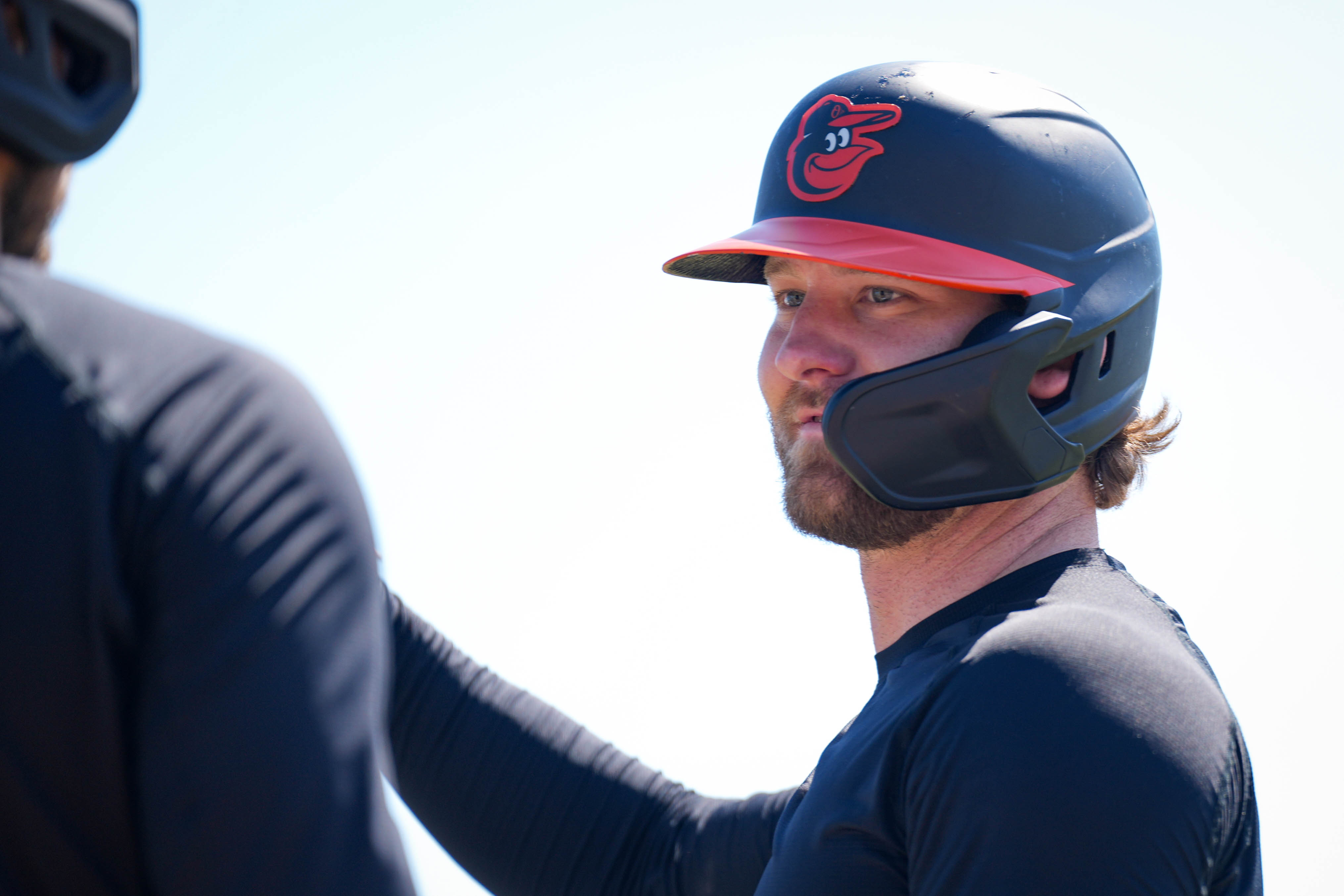 Baltimore Orioles left fielder Taylor Ward speaks with teammates during batting practice ahead of a spring training game on Feb. 20.