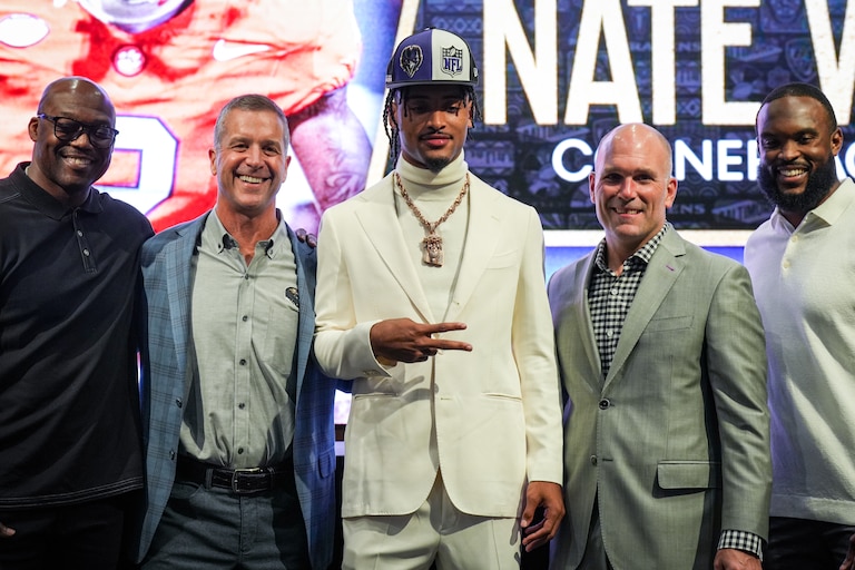 Clemson cornerback Nate Wiggins (middle), the Baltimore Ravens’ first round pick in the 2024 NFL Draft, is introduced by Ravens staff (from left) coach Chris Hewitt, head coach John Harbaugh, general manager Eric DeCosta and defensive coordinator Zach Orr at a press conference at the Under Armour Performance Center on April 26, 2024.