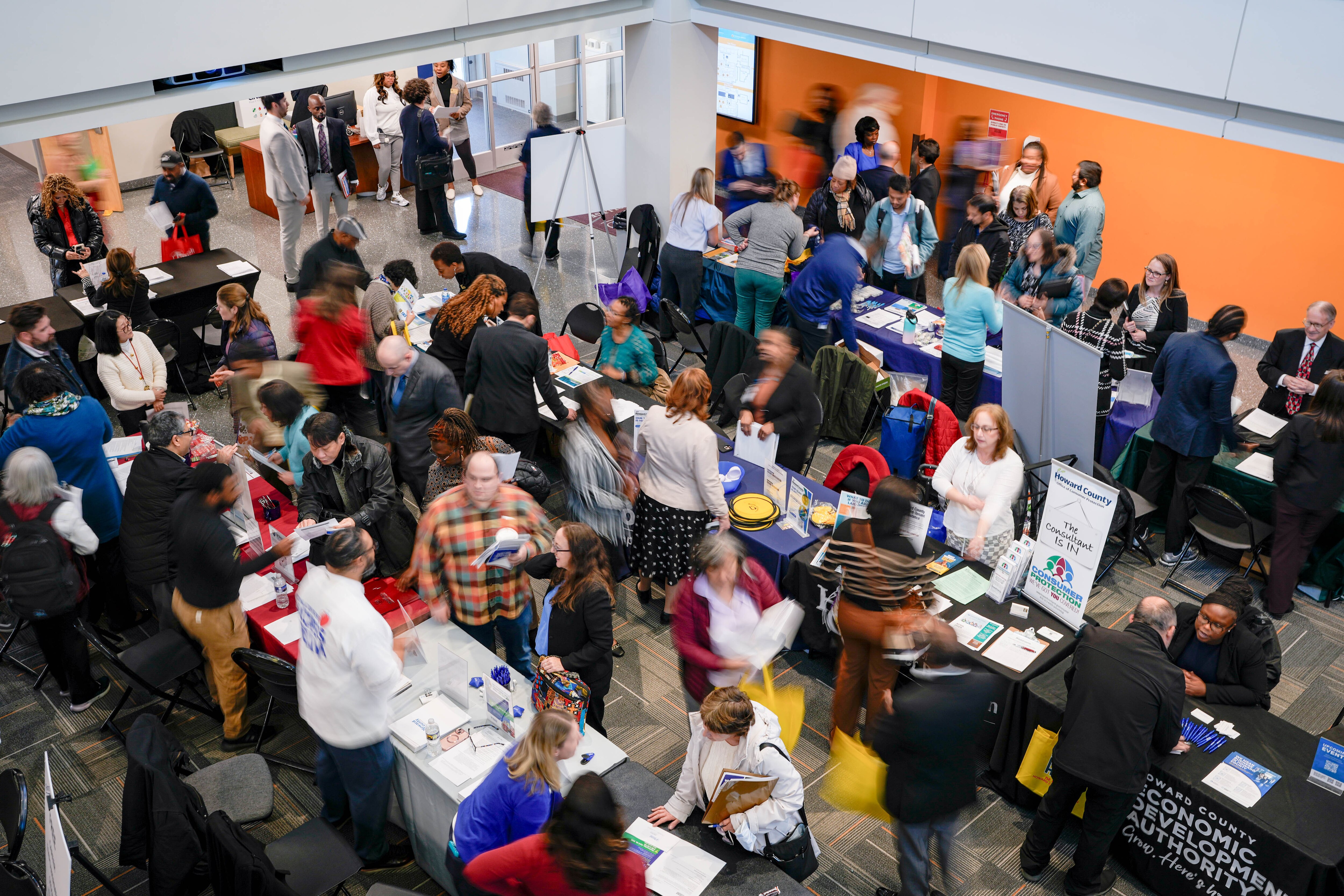 Prospective job seekers speak with recruiters during a Federal Workers Career Fair hosted at Howard Community College in Columbia on Tuesday.
