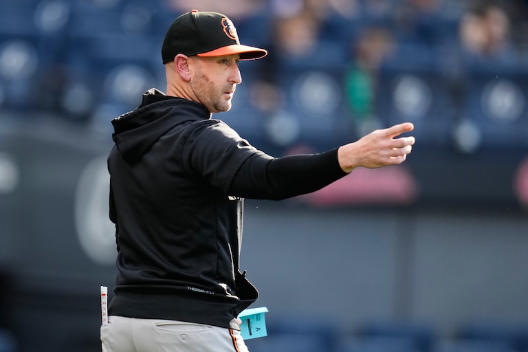 Orioles manager Craig Albernaz gestures as he walks out to home plate before a baseball game against the Cleveland Guardians in Cleveland.