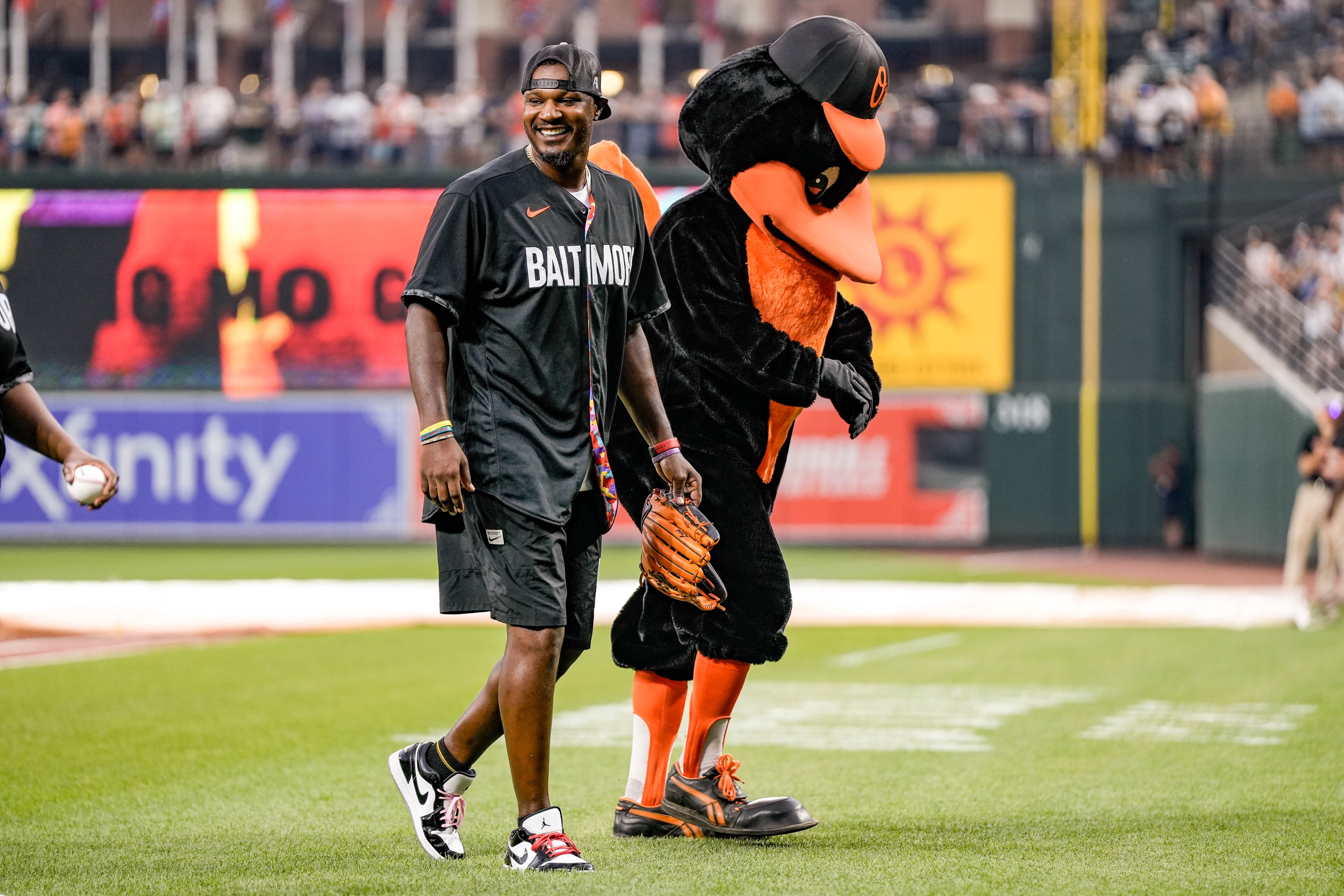 Former Orioles outfielder Adam Jones walks back to the dugout with the Oriole Bird at the first game of their series against the Yankees on July 28, 2023 at Camden Yards.