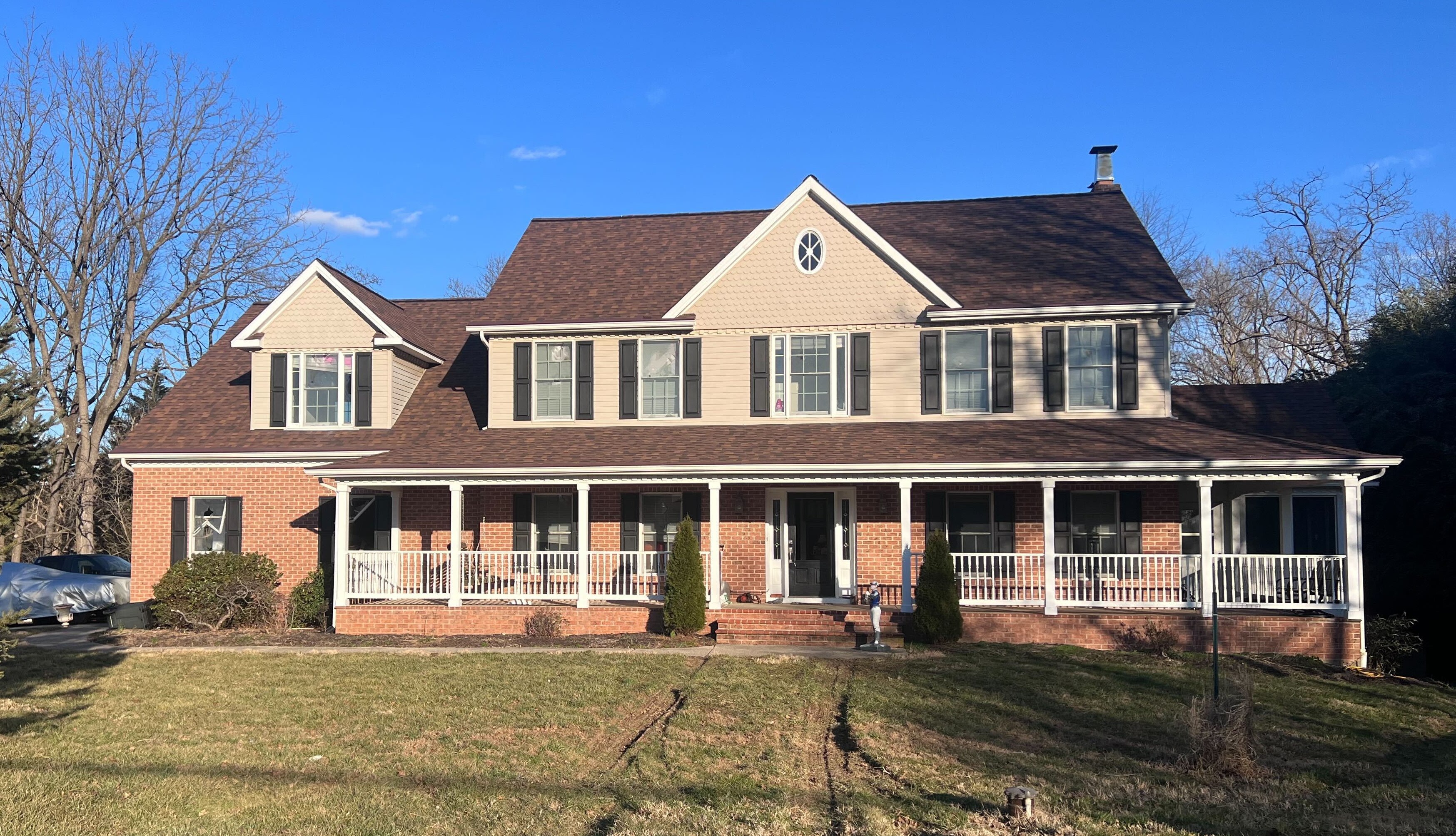 The view outside David Linthicum's home on Friday, Feb. 10. Tire tracks and busted windows are some of the signs from a police raid the night before.
