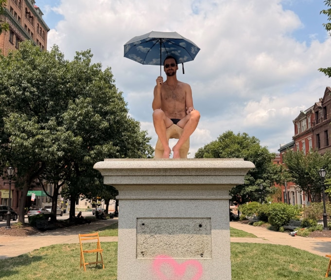 Hamb, the performance artist arrested for nude installment on a pedestal in the Inner Harbor, resurfaces in scantily clad pedestal pose in Mount Vernon on Sunday, July 26, 2026.