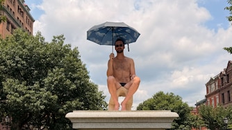 Hamb, the performance artist arrested for nude installment on a pedestal in the Inner Harbor, resurfaces in scantily clad pedestal pose in Mount Vernon on Sunday, July 26, 2026.