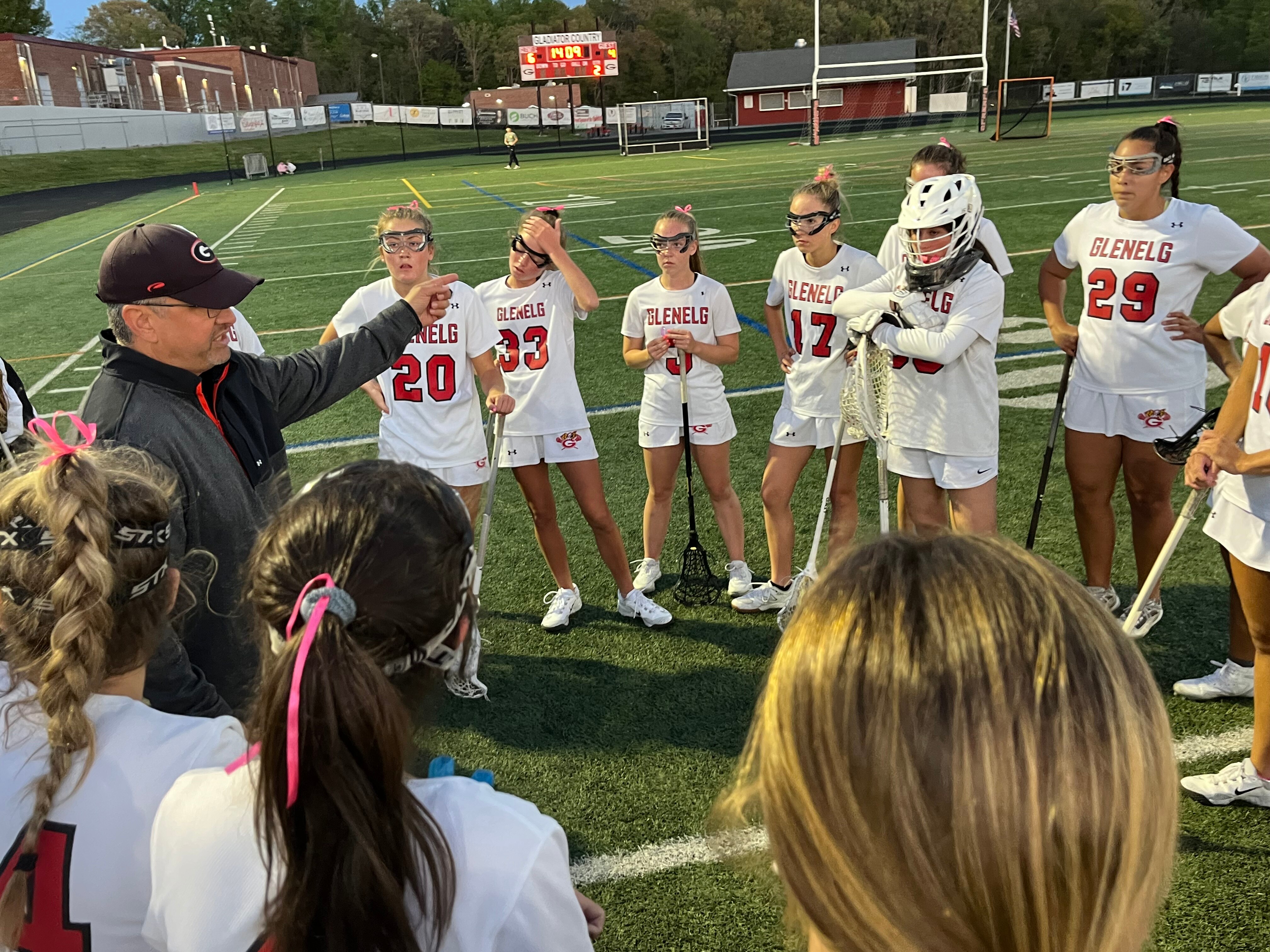 Glenelg girls lacrosse coach Alex Pagnotta (left) talks to his team during a timeout in Tuesday's Howard County match with Marriotts Ridge. The No. 7 Gladiators overcame a shaky second half effort to post a 7-5 victory over the 13th-ranked Mustangs in Western Howard County.