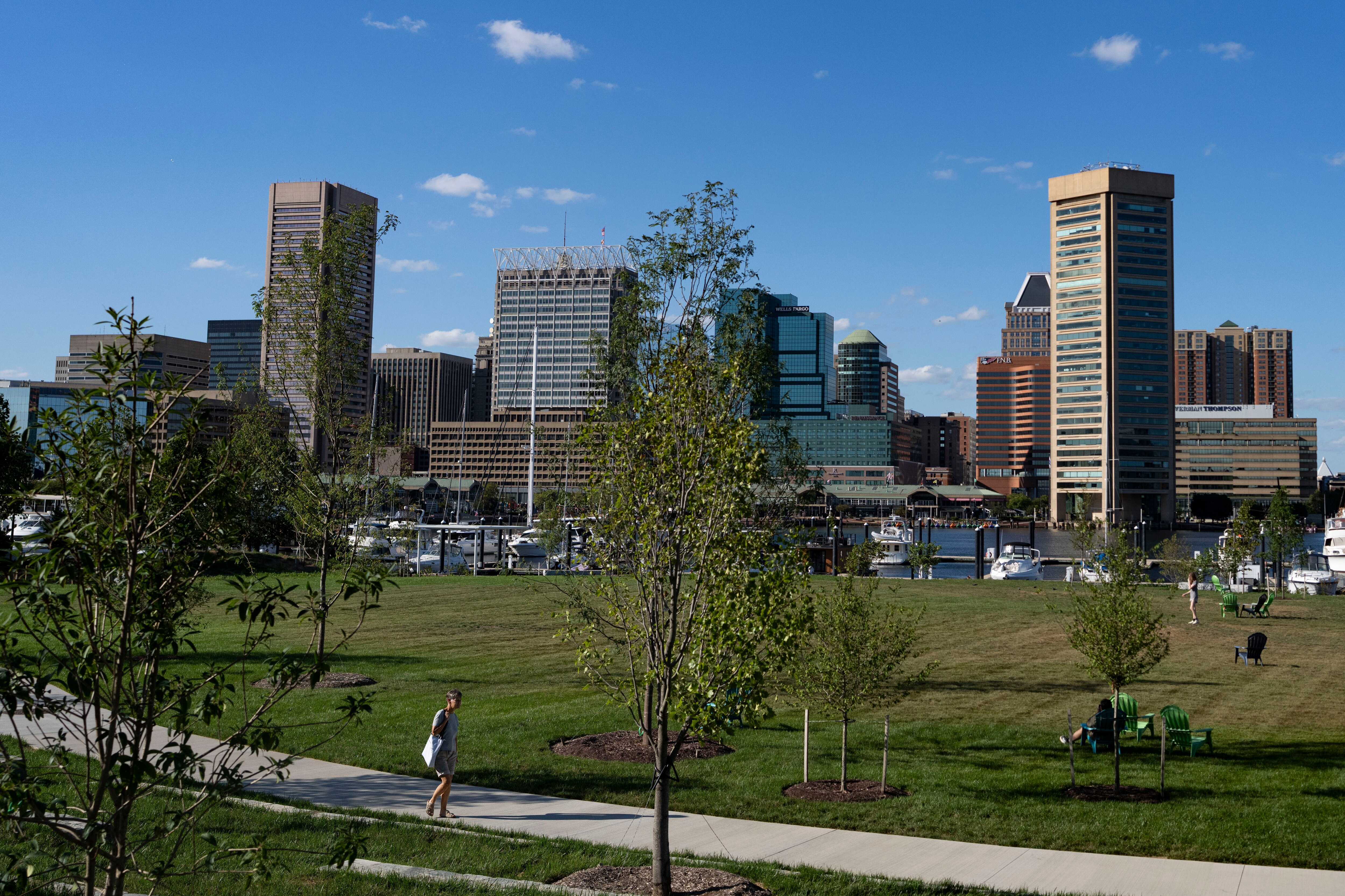 Pedestrians walk through Rash Field Park in Baltimore.