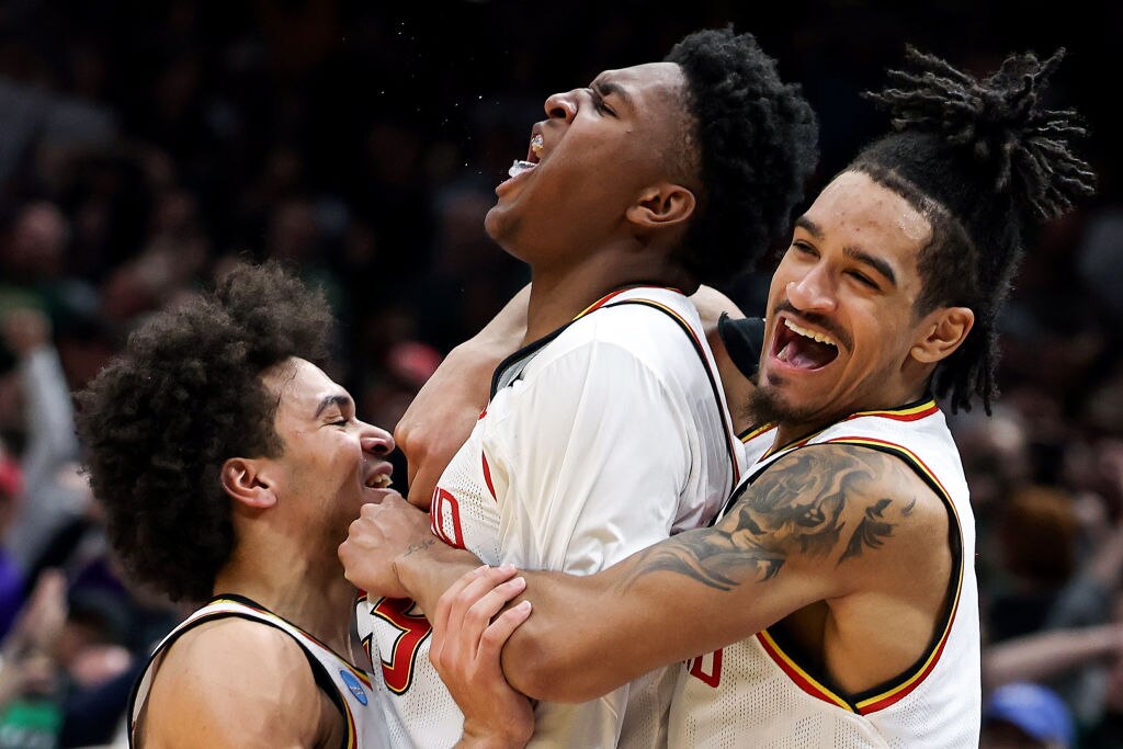Derik Queen of the Maryland Terrapins celebrates with teammates after making a shot to defeat the Colorado State Rams.
