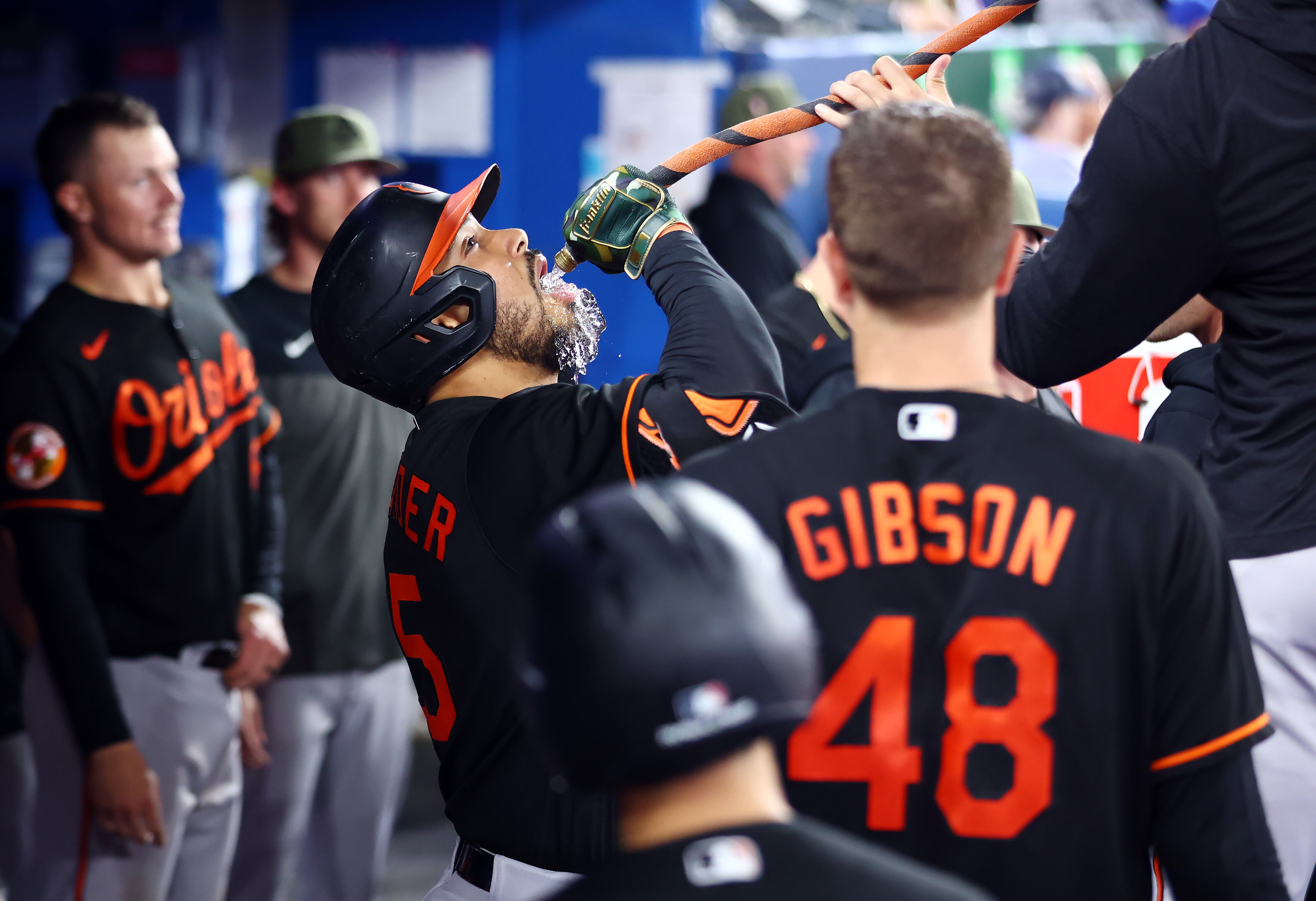 Anthony Santander #25 of the Baltimore Orioles drinks from a funnel after hitting a solo home run in the sixth inning against the Toronto Blue Jays at Rogers Centre on May 19, 2023 in Toronto, Ontario, Canada.