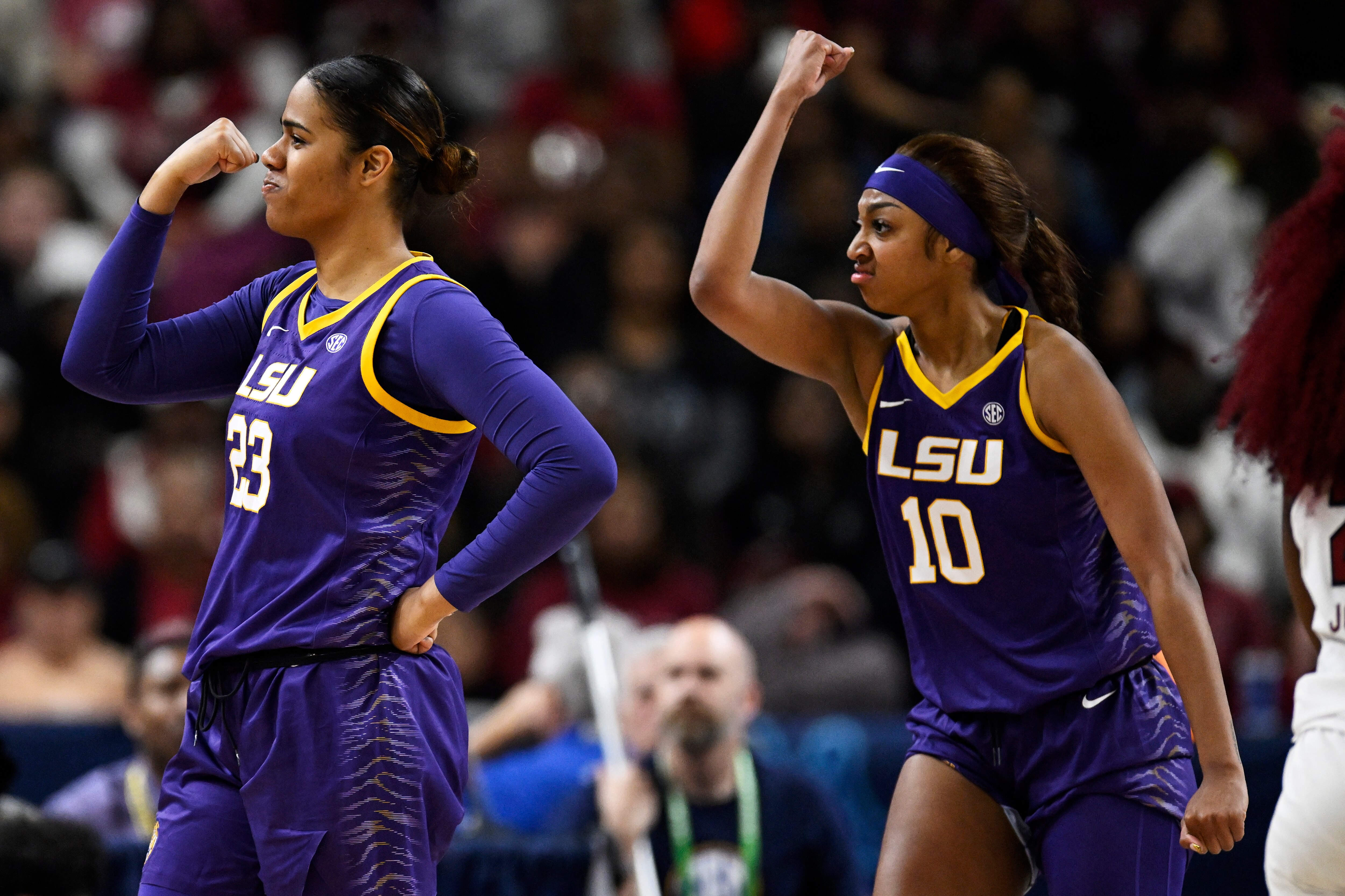 Angel Reese (right) and Aalyah Del Rosario of LSU get the players on the court pumped up during a game against South Carolina.