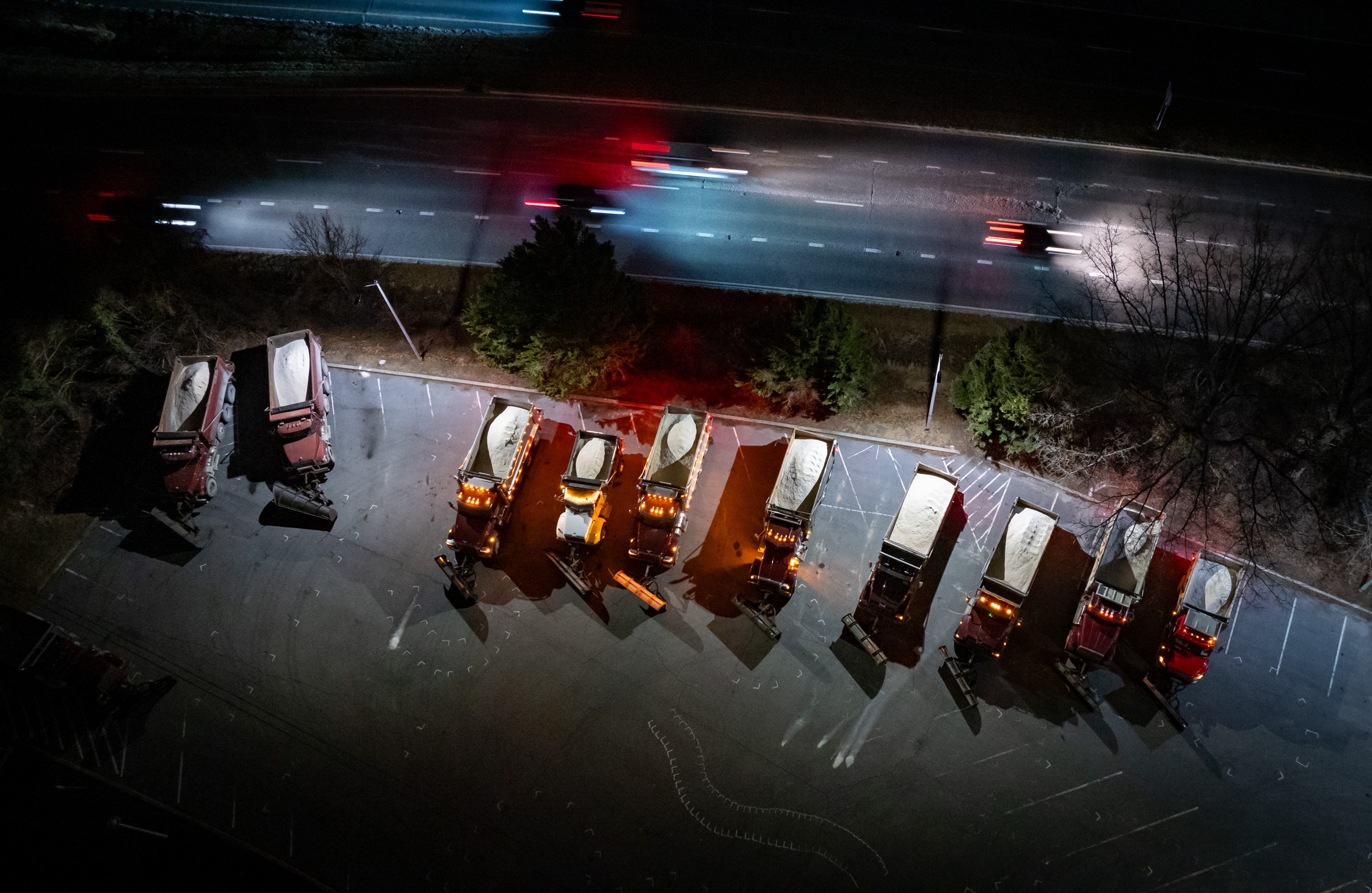 Snow plows idle in the State Highway Administration parking lot at Falls Road and Joppa Road in January ahead of a major snowstorm.