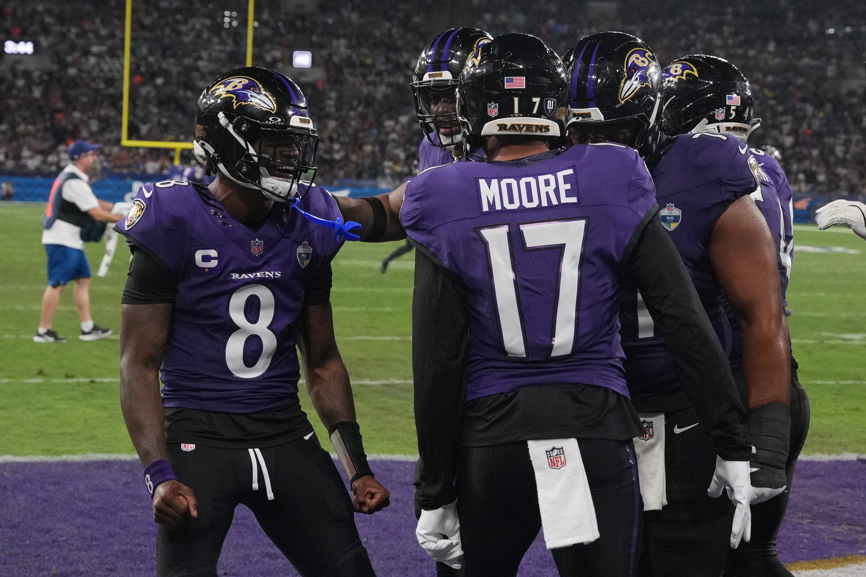 Baltimore Ravens wide receiver Chris Moore (17) celebrates with quarterback Lamar Jackson (8) after a touchdown during the second half of an NFL football game against the Dallas Cowboys in Rio de Janeiro, Sunday, Sept. 27, 2026. (AP Photo/Fernando Llano)