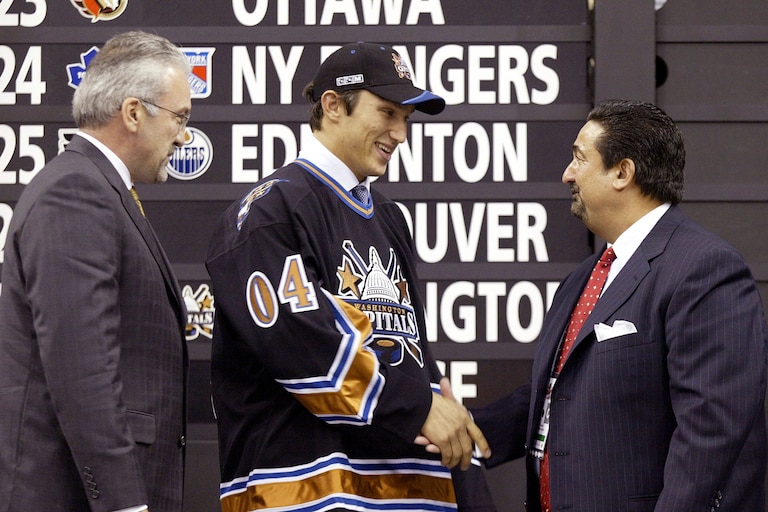 Alexander Ovechkin, center, of Russia, shakes hands with Washington Capitals officials after being selected as the No. 1 overall pick in the NHL Draft, Saturday, June 26, 2004, at the RBC Center in Raleigh, N.C.