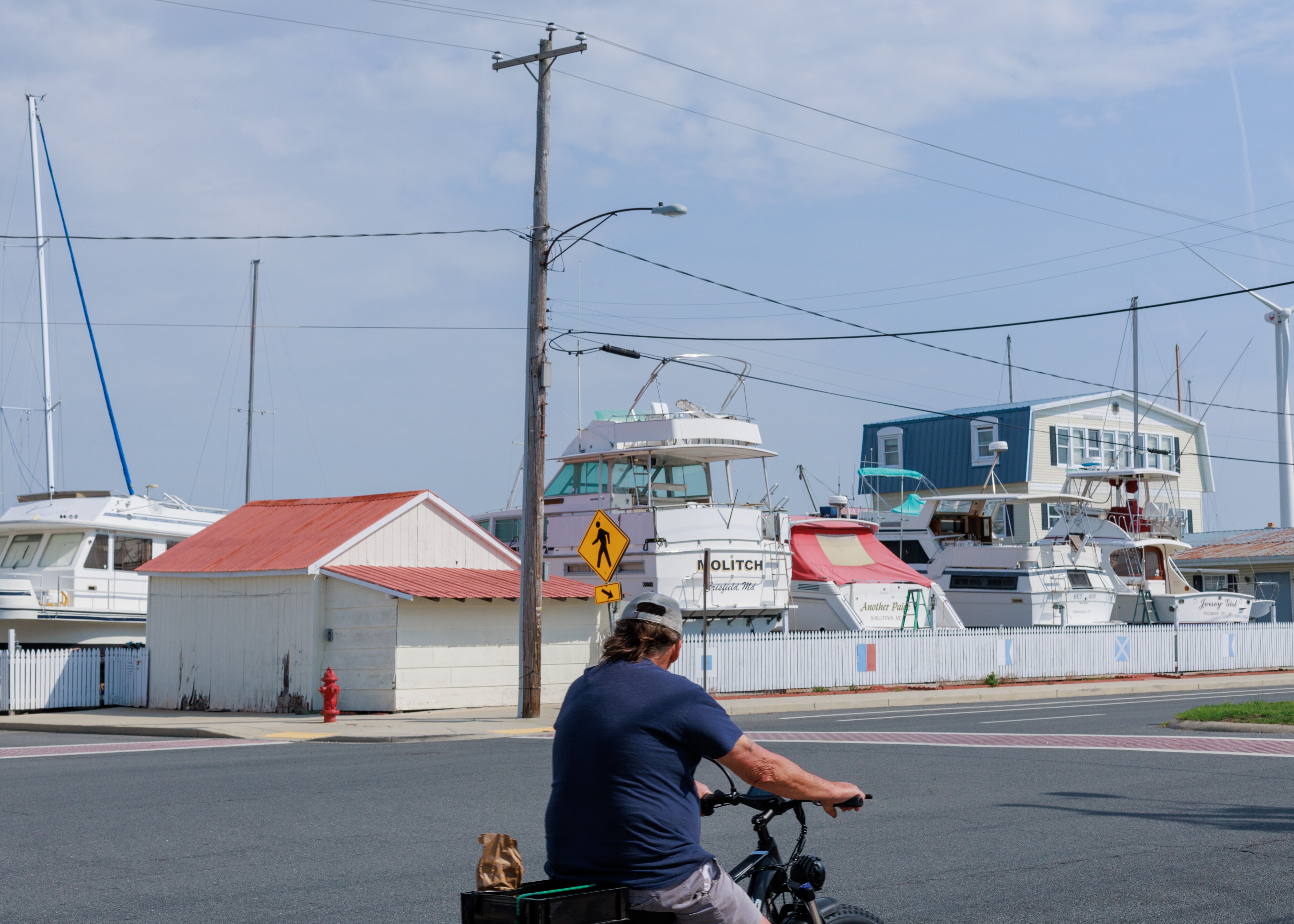 A man rides his bike in downtown Crisfield, MD on April 26, 2025.