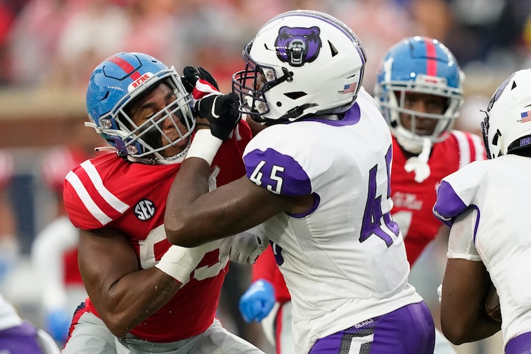 Mississippi defensive end Tavius Robinson (95) left, tries to fight off the block of Central Arkanas tight end Jordan Owens (45) during the first half of an NCAA college football game in Oxford, Miss., Saturday, Sept. 10, 2022. Mississippi won 59-3.