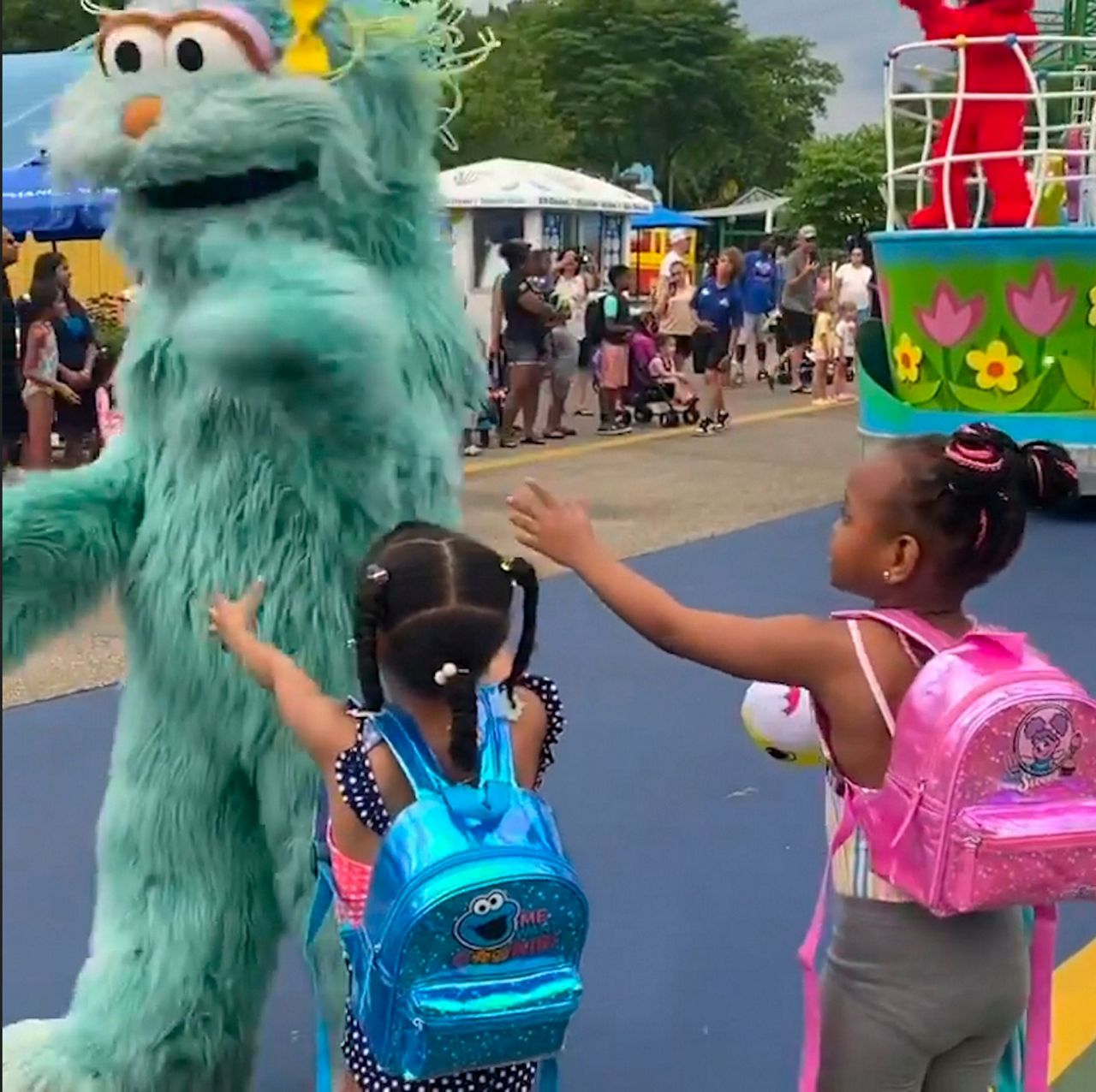 In this image from video provided by Jodi Brown, posted to Instagram on Saturday, July 16, 2022, a performer dressed as the character Rosita waves off Brown's daughter and another 6-year-old Black girl at the Sesame Place amusement park in Langhorne, Pa.