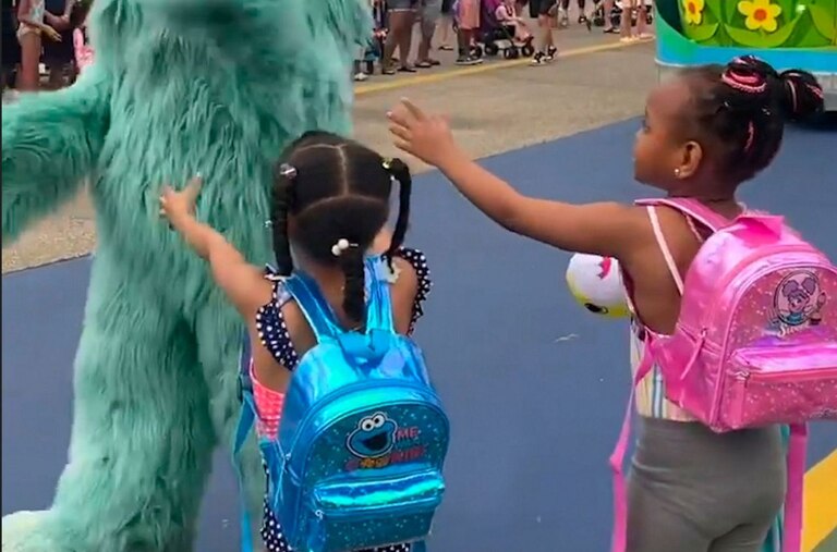In this image from video provided by Jodi Brown, posted to Instagram on Saturday, July 16, 2022, a performer dressed as the character Rosita waves off Brown's daughter and another 6-year-old Black girl at the Sesame Place amusement park in Langhorne, Pa.