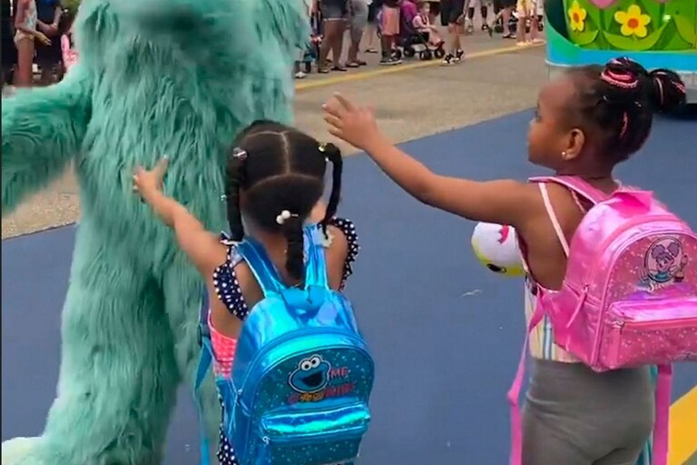 In this image from video provided by Jodi Brown, posted to Instagram on Saturday, July 16, 2022, a performer dressed as the character Rosita waves off Brown's daughter and another 6-year-old Black girl at the Sesame Place amusement park in Langhorne, Pa.