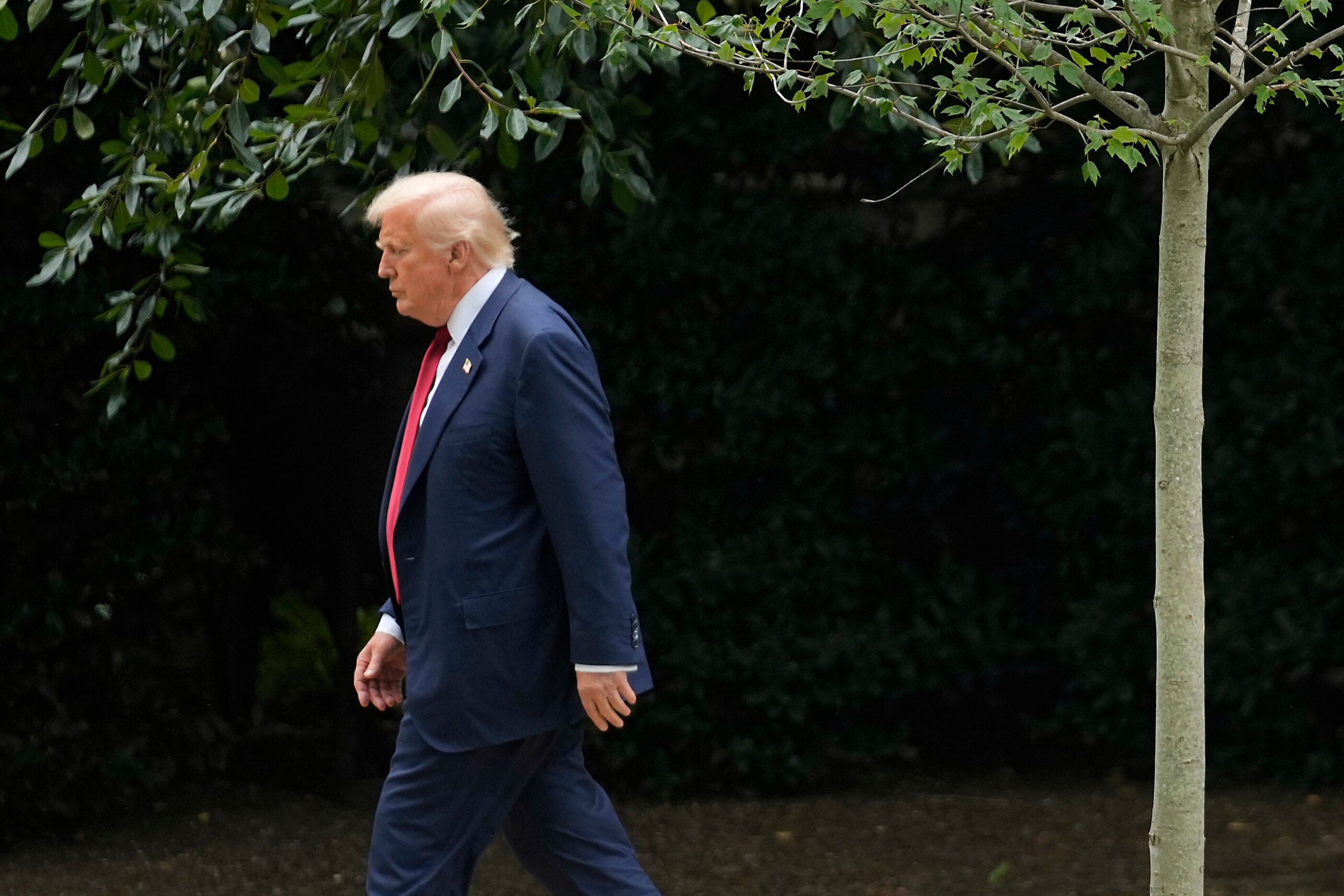 President Donald Trump walks to speak with reporters on the South Lawn of the White House before he boards Marine One en route to Joint Base Andrews, Md., Friday, Aug. 1, 2025, in Washington.
