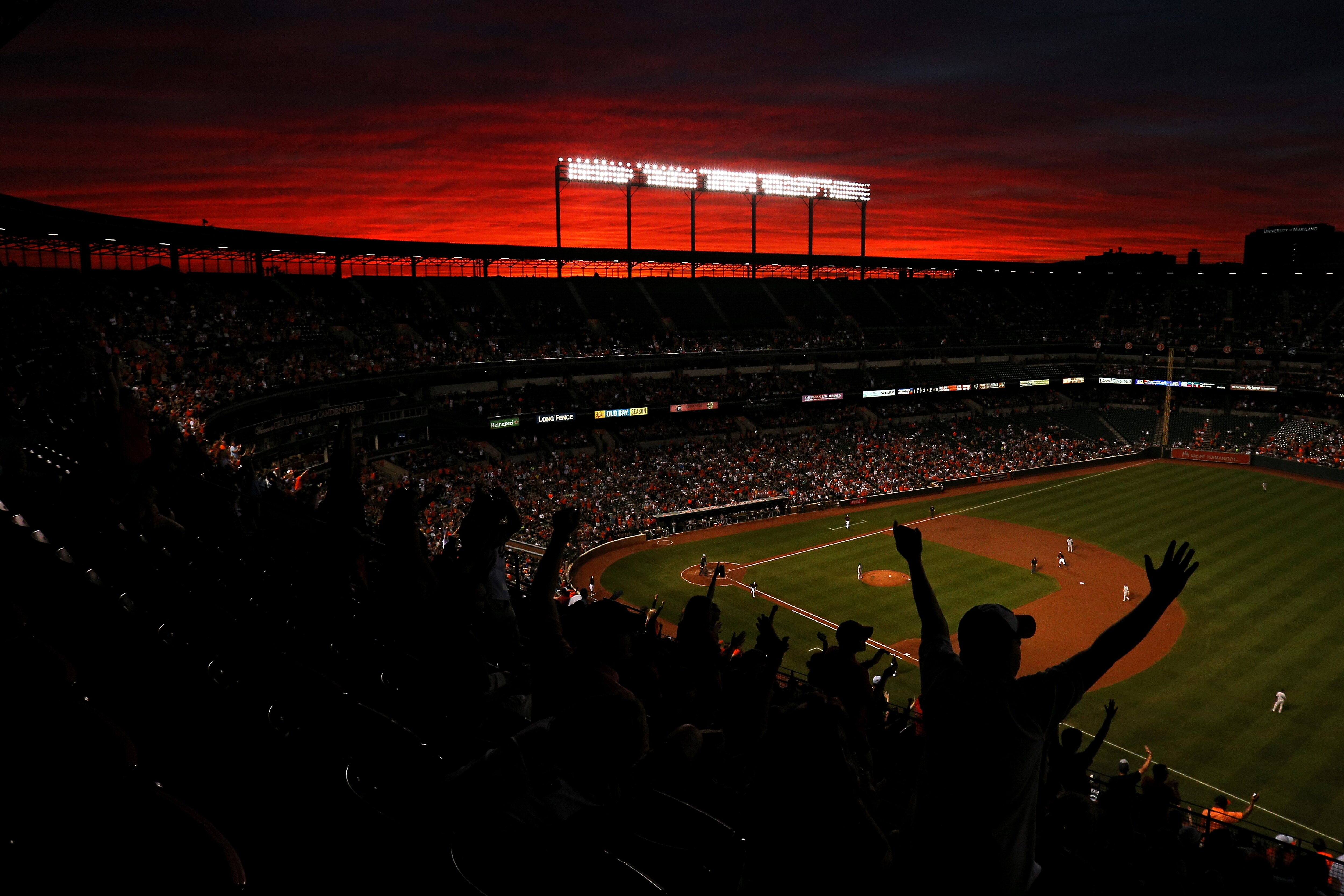 Fans cheer under a sunset as Pedro Alvarez #24 of the Baltimore Orioles rounds the bases after hitting a two run home run against the New York Yankees during the second inning at Oriole Park at Camden Yards on September 2, 2016 .