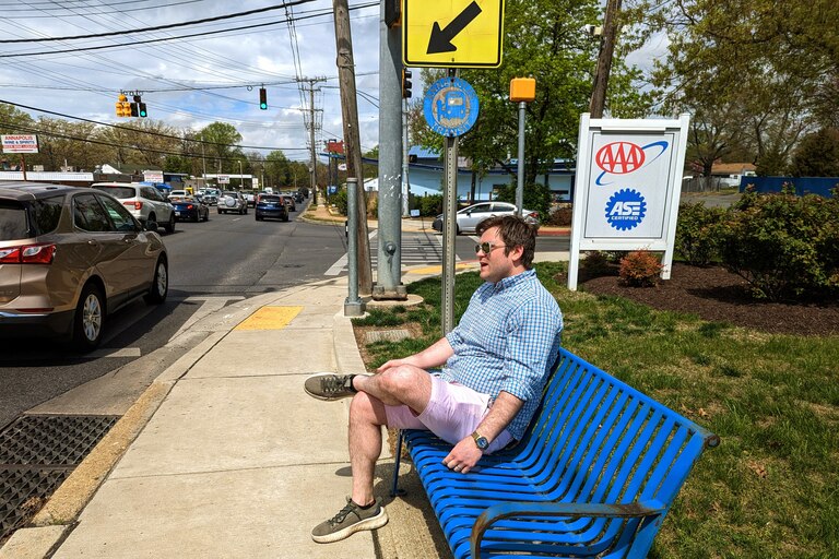Alderman Brooks Schandelmeier shouts over traffic noise from an uncovered bus stop on Forest Drive at Tyler Avenue. He said he could see the intersection one day being a mix of new commercial space and housing, situated around a traffic circle to slow cars.