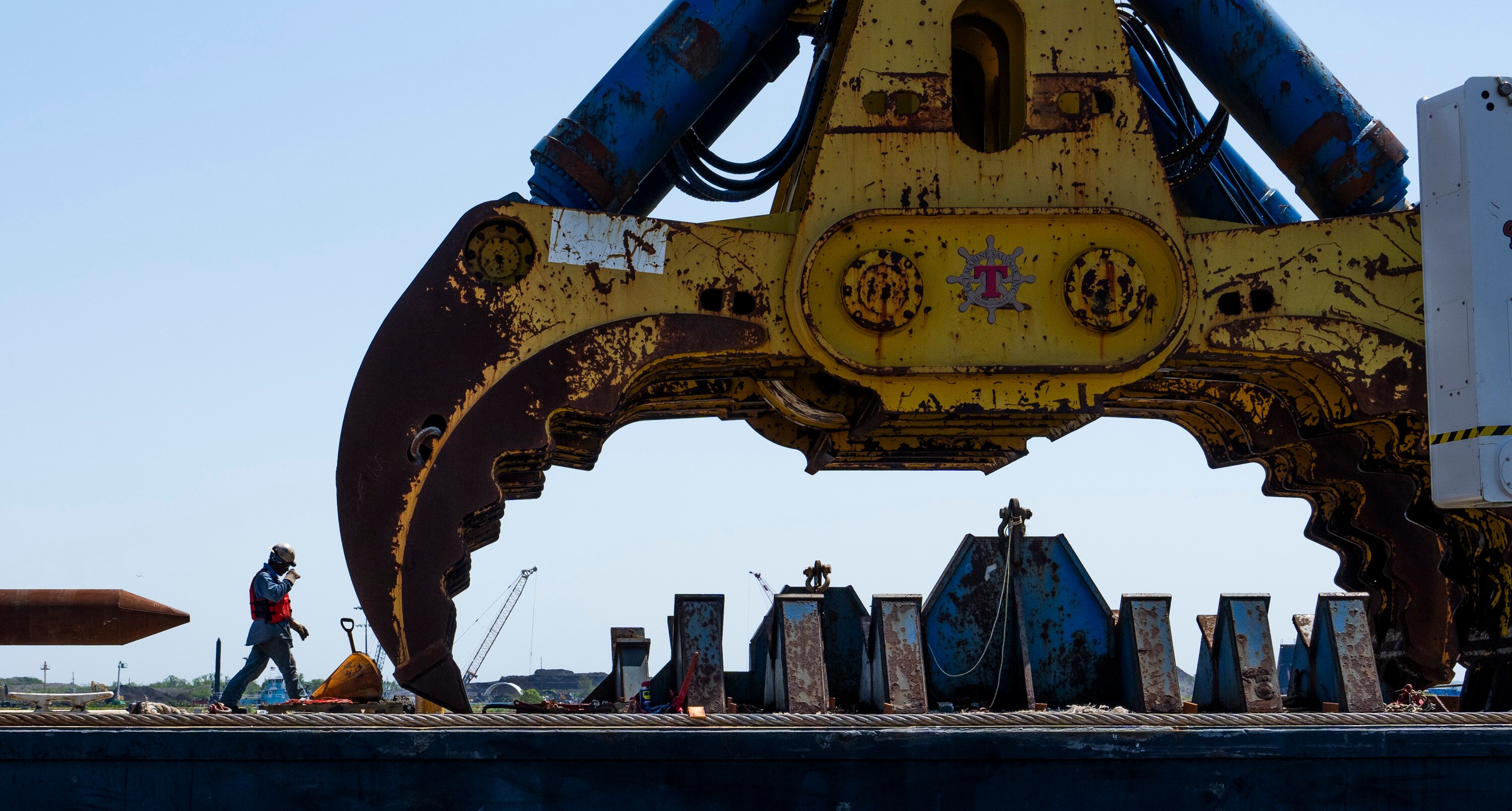 A port worker is pictured next to the 1000-metric-ton wreck grab that is attached to the Chesapeake 1000, a large crane.