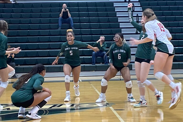 Glenelg Country School's volleyball team celebrates after securing the winning point in Sunday's IAAM C Conference final at Stevenson University. The Dragons swept previously undefeated Chapelgate Christian.