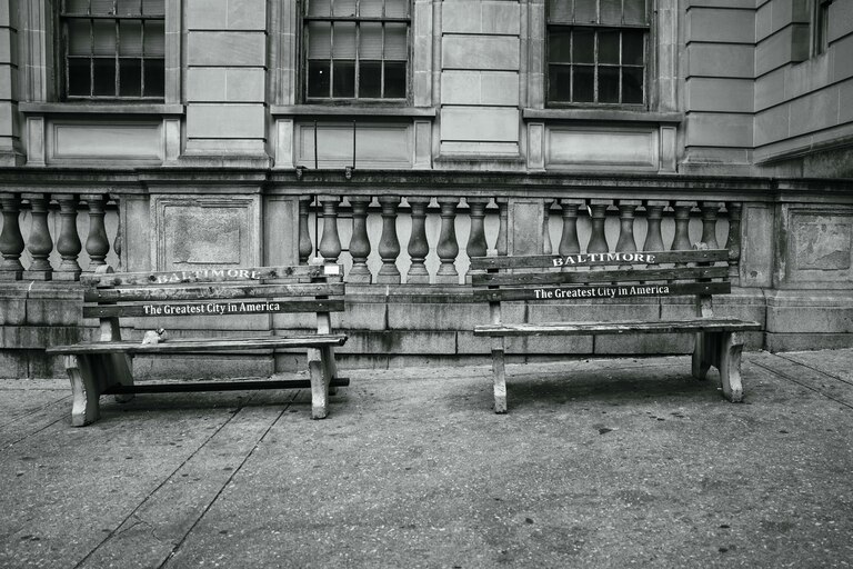 Two benches with the city slogan "Baltimore - The Greatest City in America" outside of Courthouse East.
