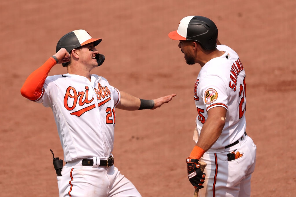 Austin Hays, #21 of the Baltimore Orioles, celebrates hitting a solo home run with Anthony Santander, #25, in the eighth inning against the Toronto Blue Jays at Oriole Park at Camden Yards on June 15, 2023 in Baltimore, Maryland.