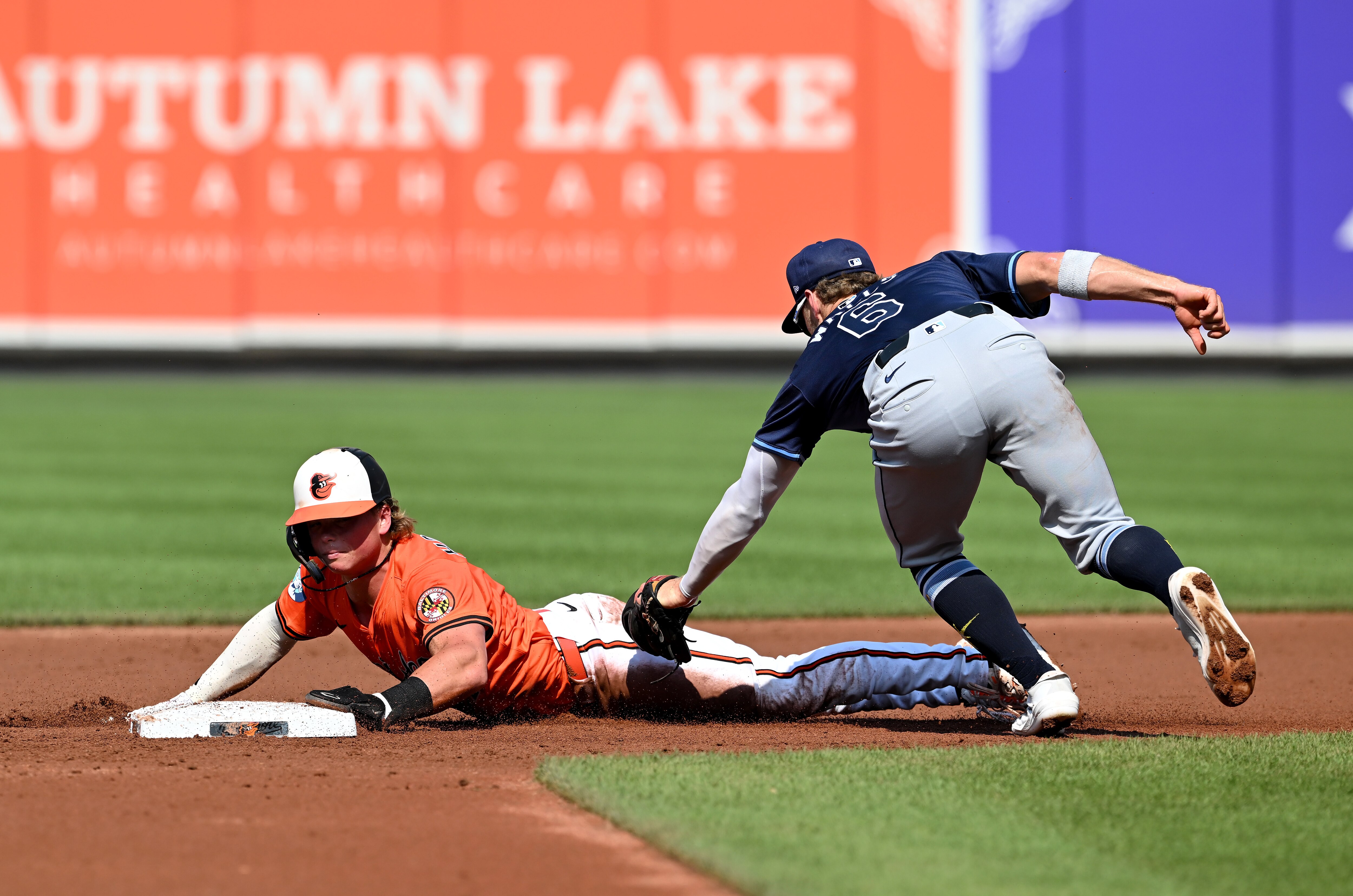 Jackson Holliday steals second base in the first inning ahead of the tag of Taylor Walls of the Tampa Bay Rays on June 28.