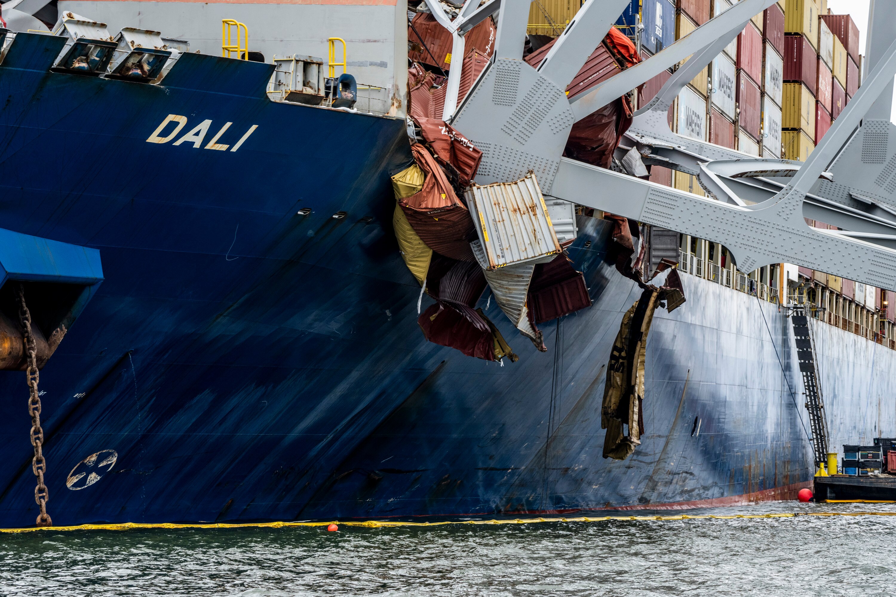 The Dali, a massive container ship from Singapore,  still sits in the wreckage and collapse of the Francis Scott Key Bridge in the Baltimore port on April 1, 2024. It has been a week since it lost power and struck the bridge , causing it to topple in seconds, taking several roadway workers and their cars with it. The once giant frame of the bridge now sits in the water and large cranes have arrived to untangle the mess.