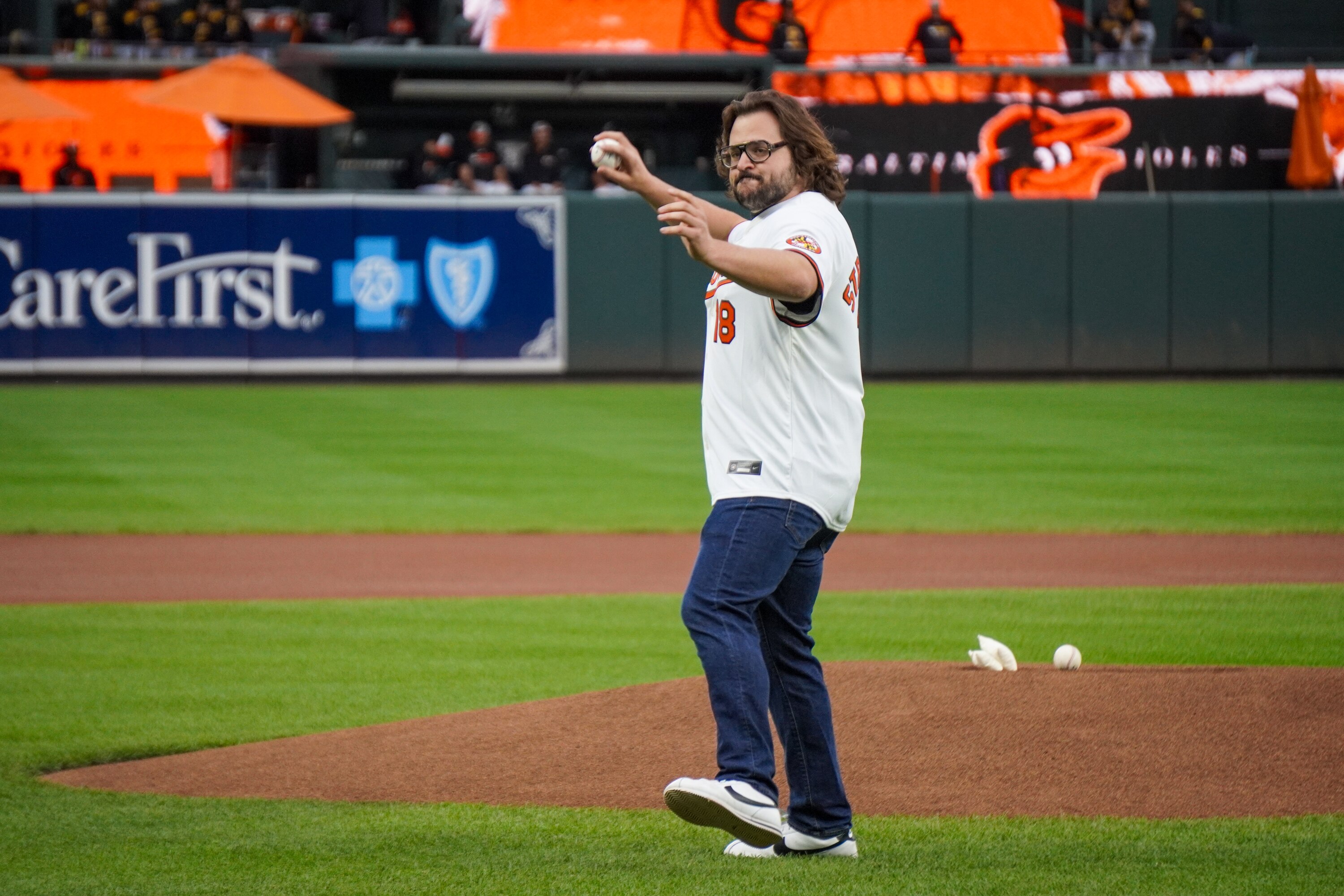 Actor Michael Strassner throws the first pitch at Camden Yards on Wednesday.