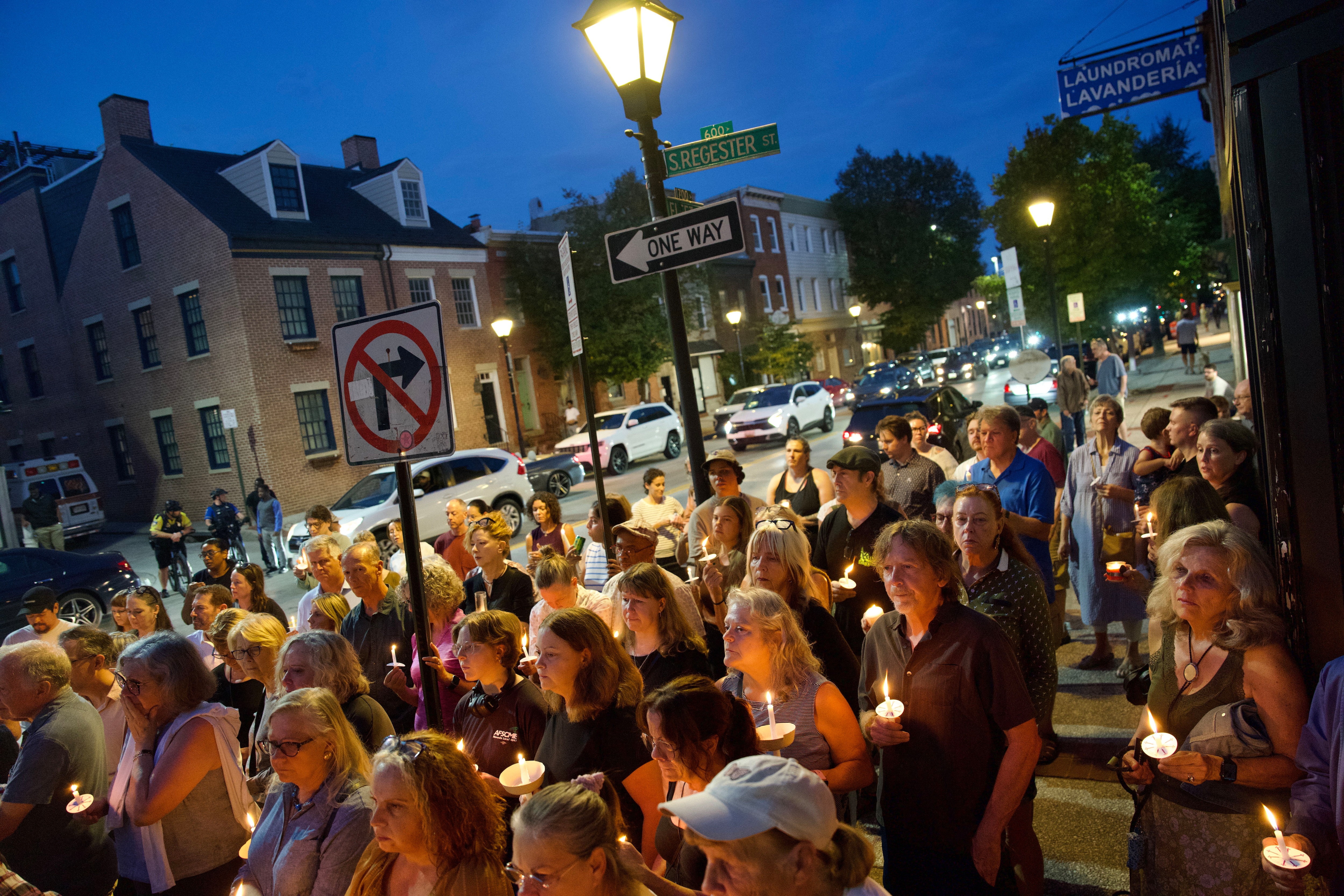 Members of the community hold a vigil for a well-known champion of the Baltimore arts scene who died after she and her husband were attacked in Fells Point.