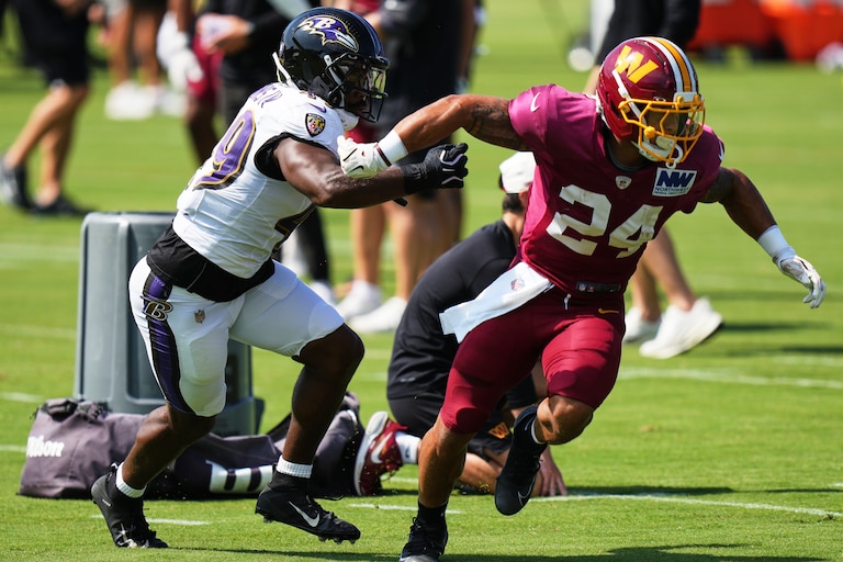 Baltimore Ravens linebacker Jay Higgins IV, left, and Washington Commanders running back Craig Reynolds (24) work out during the teams' NFL football joint training camp, Wednesday, Aug. 26, 2026, at the Under Armour Performance Center in Owings Mills, Md. (AP Photo/Stephanie Scarbrough)