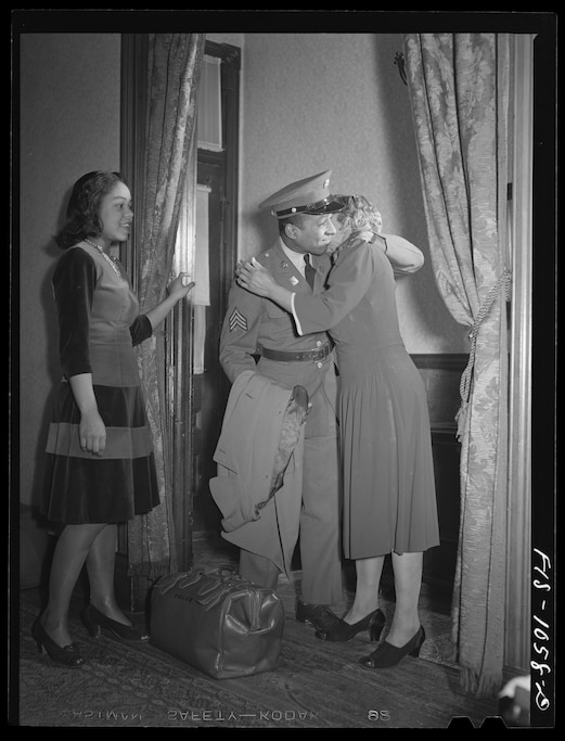 Baltimore, Maryland. Sargeant Franklin Williams, home on leave from Army duty, saying goodbye to his mother before leavng for Fort Bragg