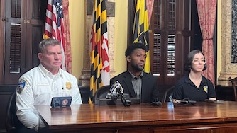 TUESDAY, OCTOBER 20, 2026 - Mayor Brandon Scott, center, with Baltimore Police Commissioner Richard Worley, left, and Stefanie Mavronis, Director of the Mayor's Office of Neighborhood Safety and Engagement, speaks to press after summoning his public safety leadership teams to City Hall to discuss a spate of recent violence on Tuesday.