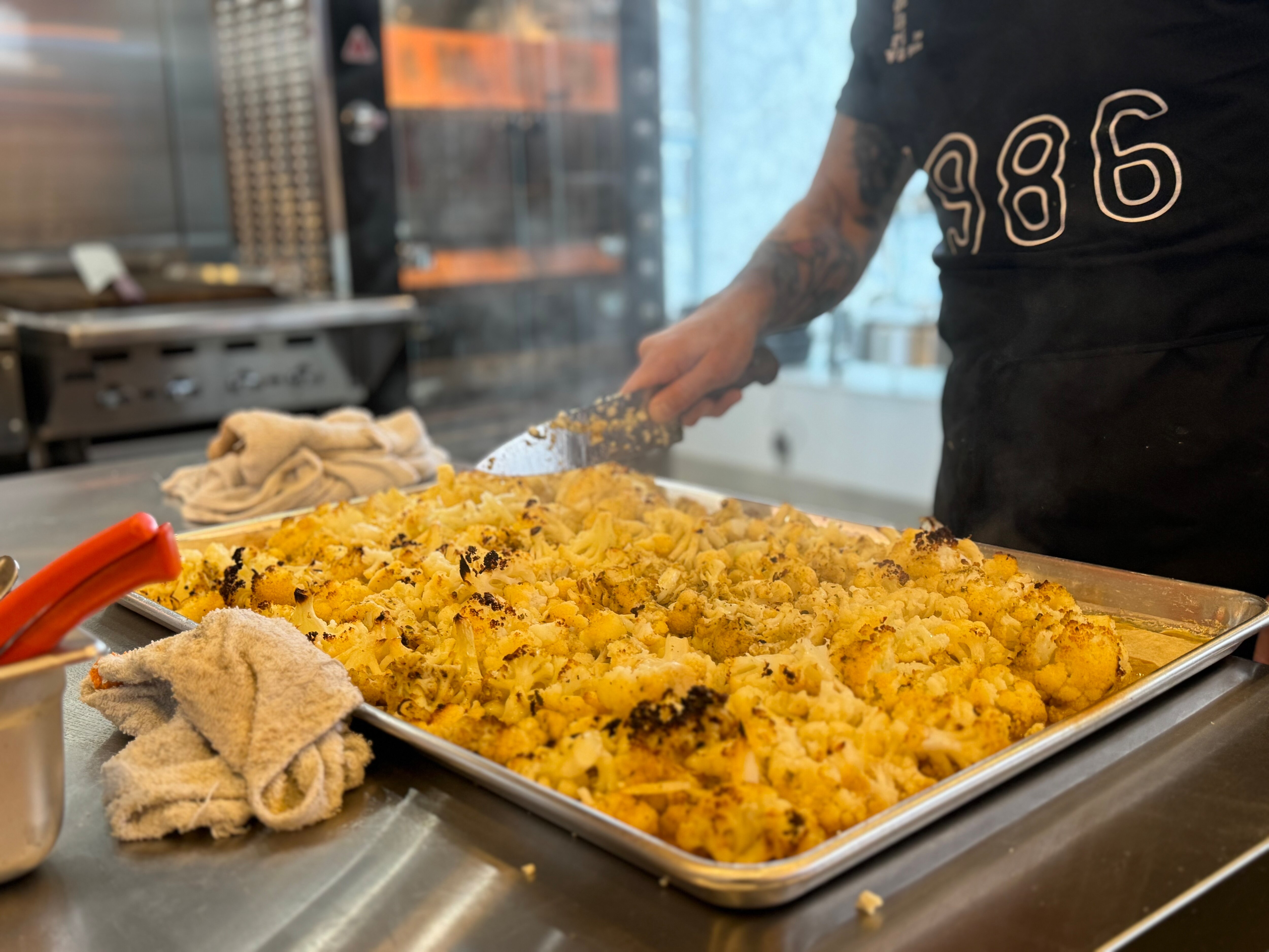 Carlos Raba chops spiced cauliflower for vegan tacos at Nana — one of a different Baltimore County chef's favorite restaurants.