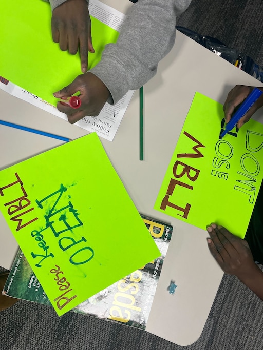 MECCA Business Learning Institute students make signs ahead of a school board meeting in support of keeping their charter school open on Thursday, Jan. 22, 2026, in Rockville.