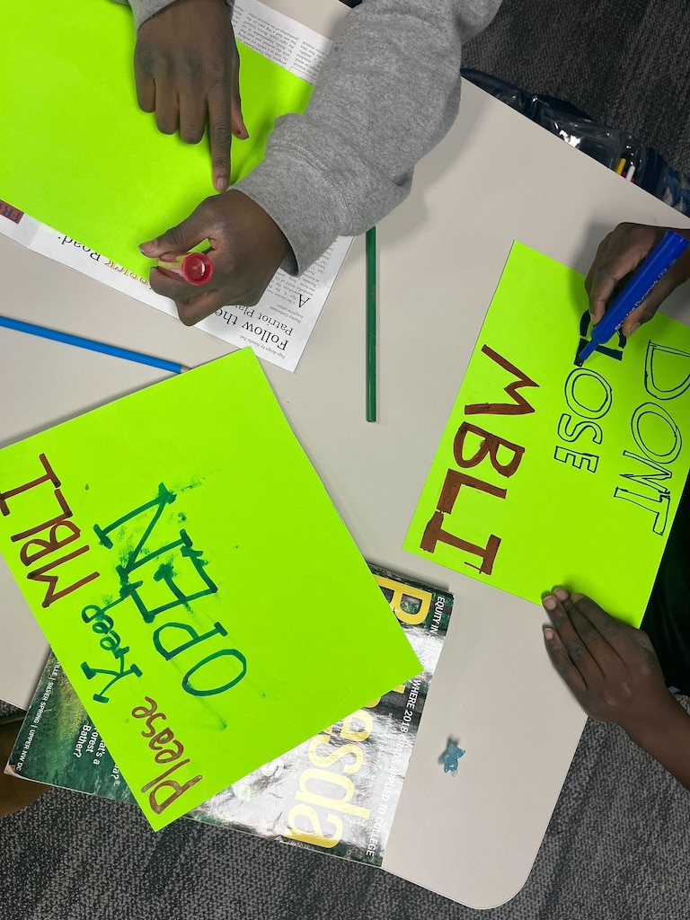 MECCA Business Learning Institute students make signs ahead of a school board meeting in support of keeping their charter school open on Thursday, Jan. 22, 2026, in Rockville.