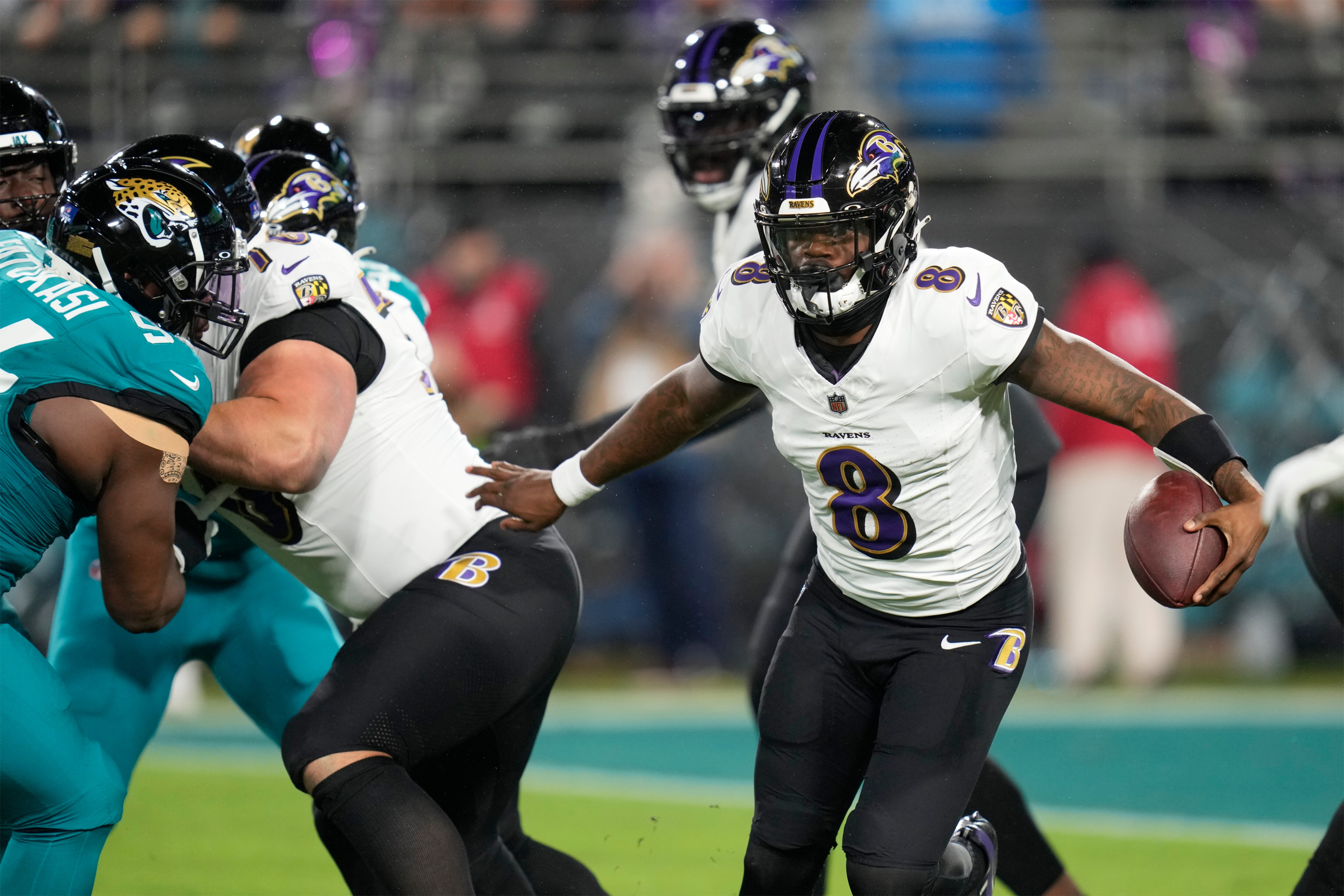 Baltimore Ravens quarterback Lamar Jackson (8) scrambles against the Jacksonville Jaguars in the first half of an NFL football game Sunday, Dec. 17, 2023, in Jacksonville, Fla.
